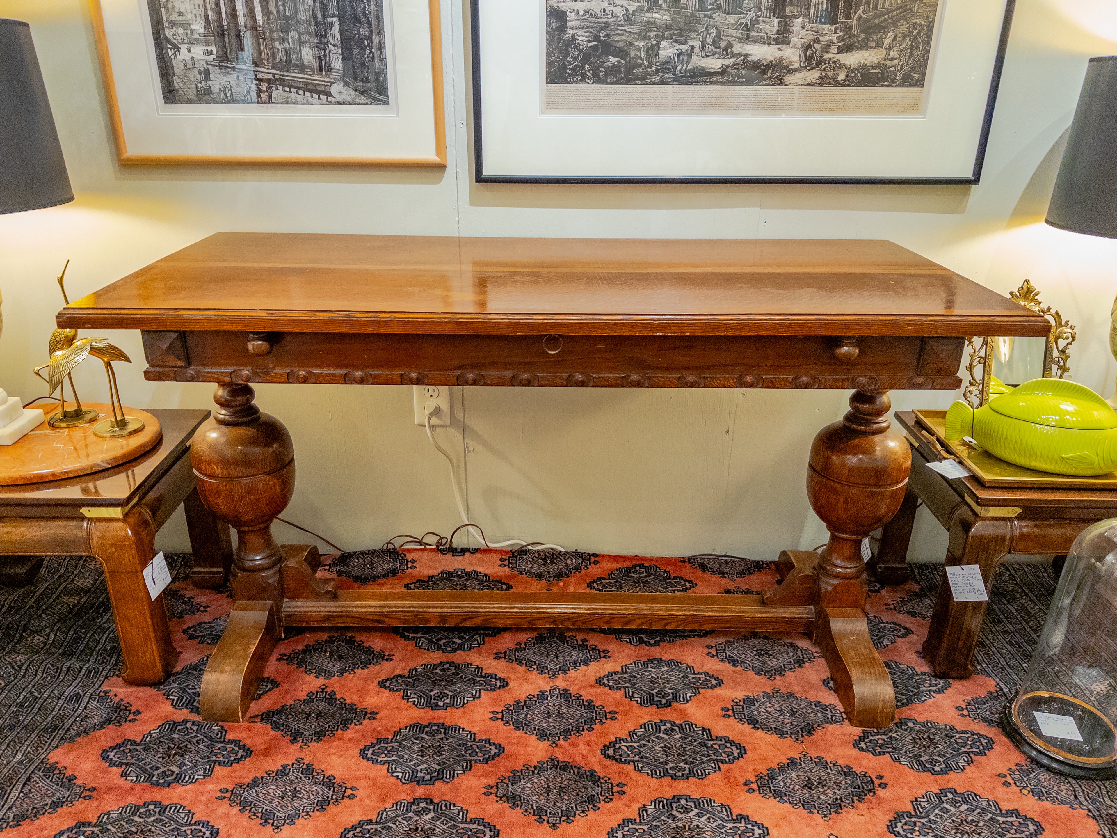Transport yourself to the elegance of the 1920s with this charming English Oak Butterfly Table, a testament to the era's fine craftsmanship. The table boasts a trestle base, exuding a rustic yet sophisticated charm typical of the period. Crafted