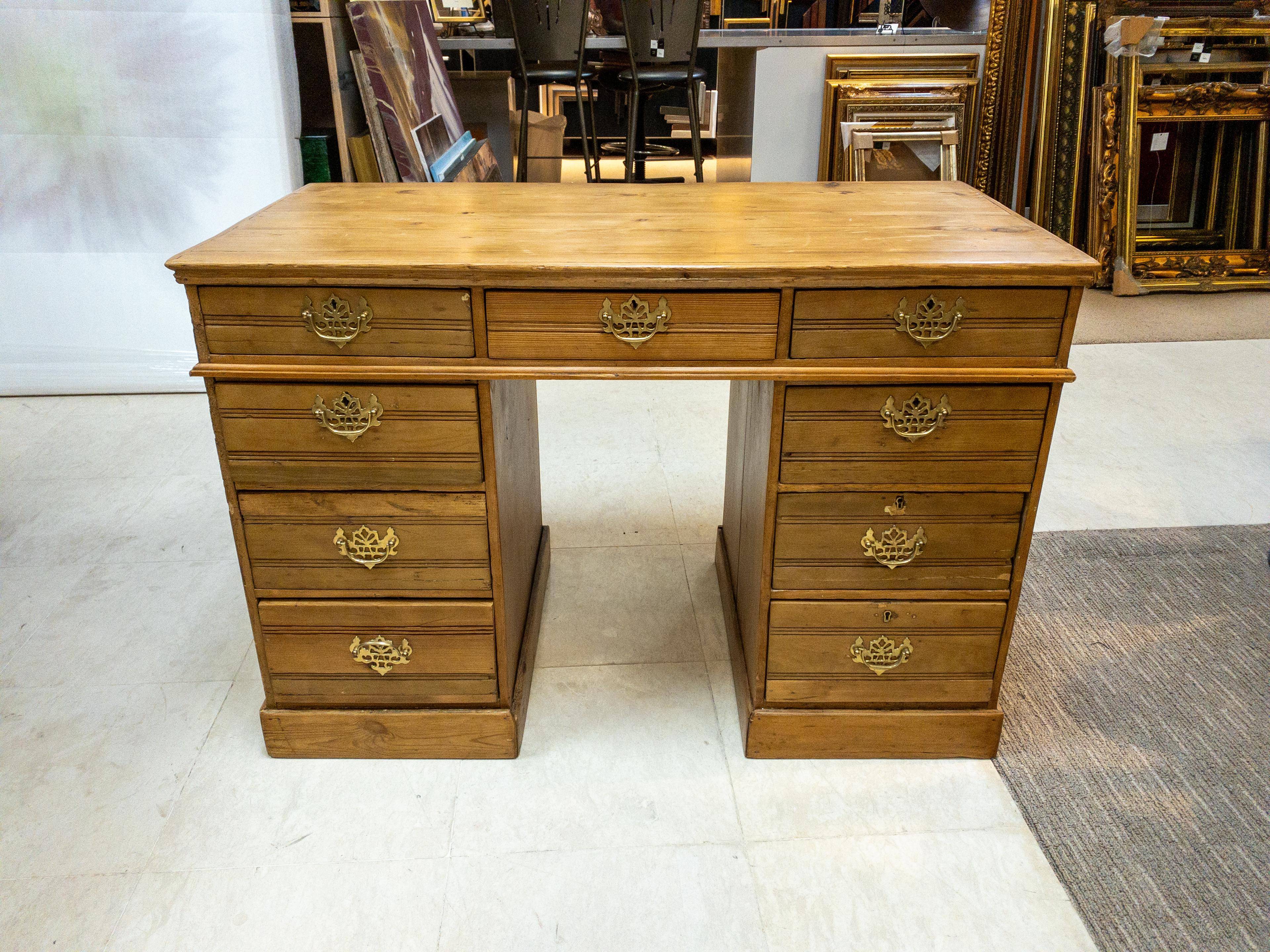 The 1920s English Pine Desk exudes timeless charm with its elegant craftsmanship and functional design. Constructed from rich, solid pine, it boasts a warm, inviting hue that adds character to any workspace or study. Standing proud with its sturdy
