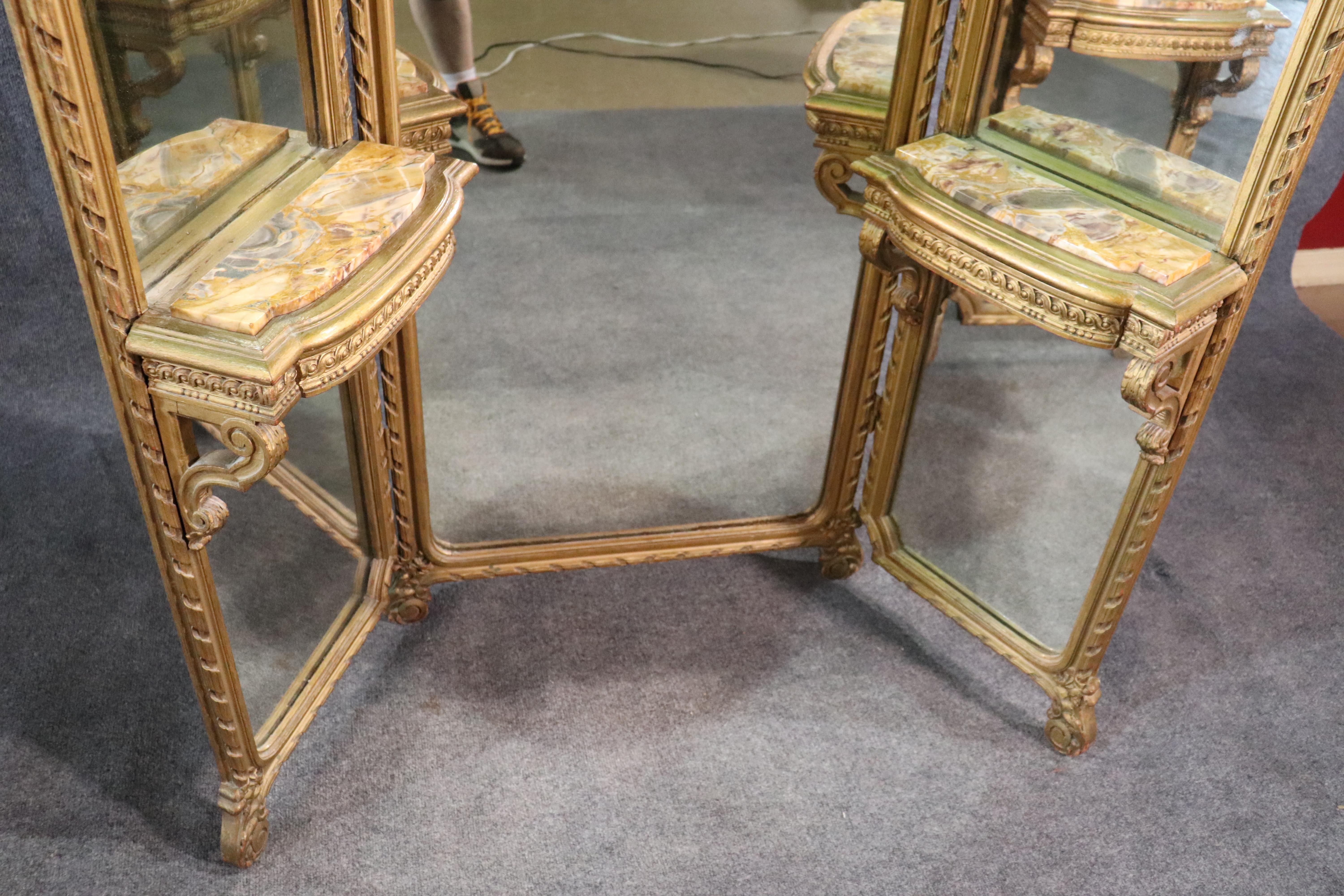 This is one of the finer French folding carved ladies vanities we have had in a long time. The carving and original gold surface are spectacular and extremely well done. The marble is a very unique color palette and is very pleasant to look at. The