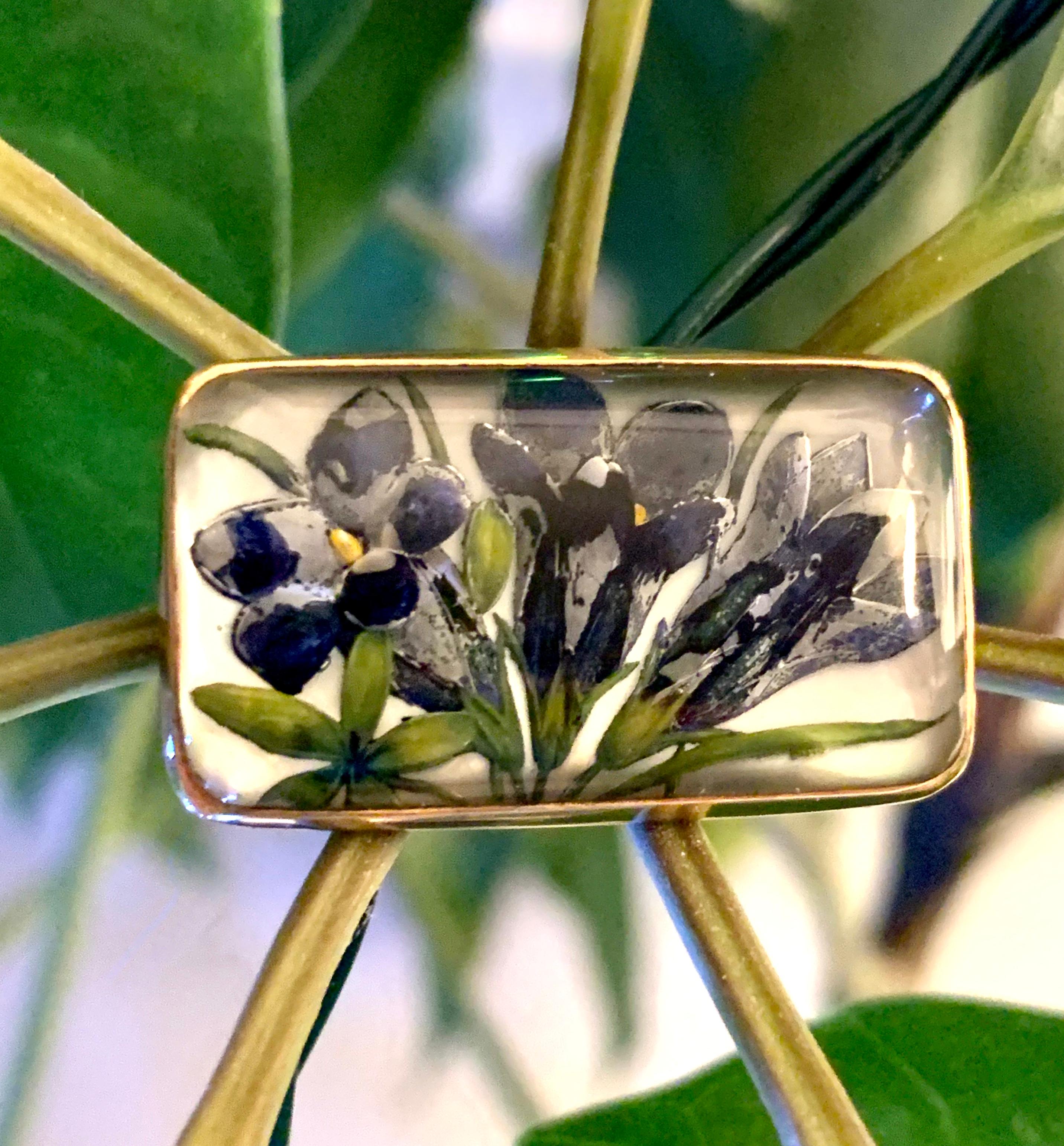 This intriguing 1920's Essex Crystal Glass brooch/pin features a depiction of a floral bouquet of Iris flowers.  Essex Crystal is sometimes referred to as a 