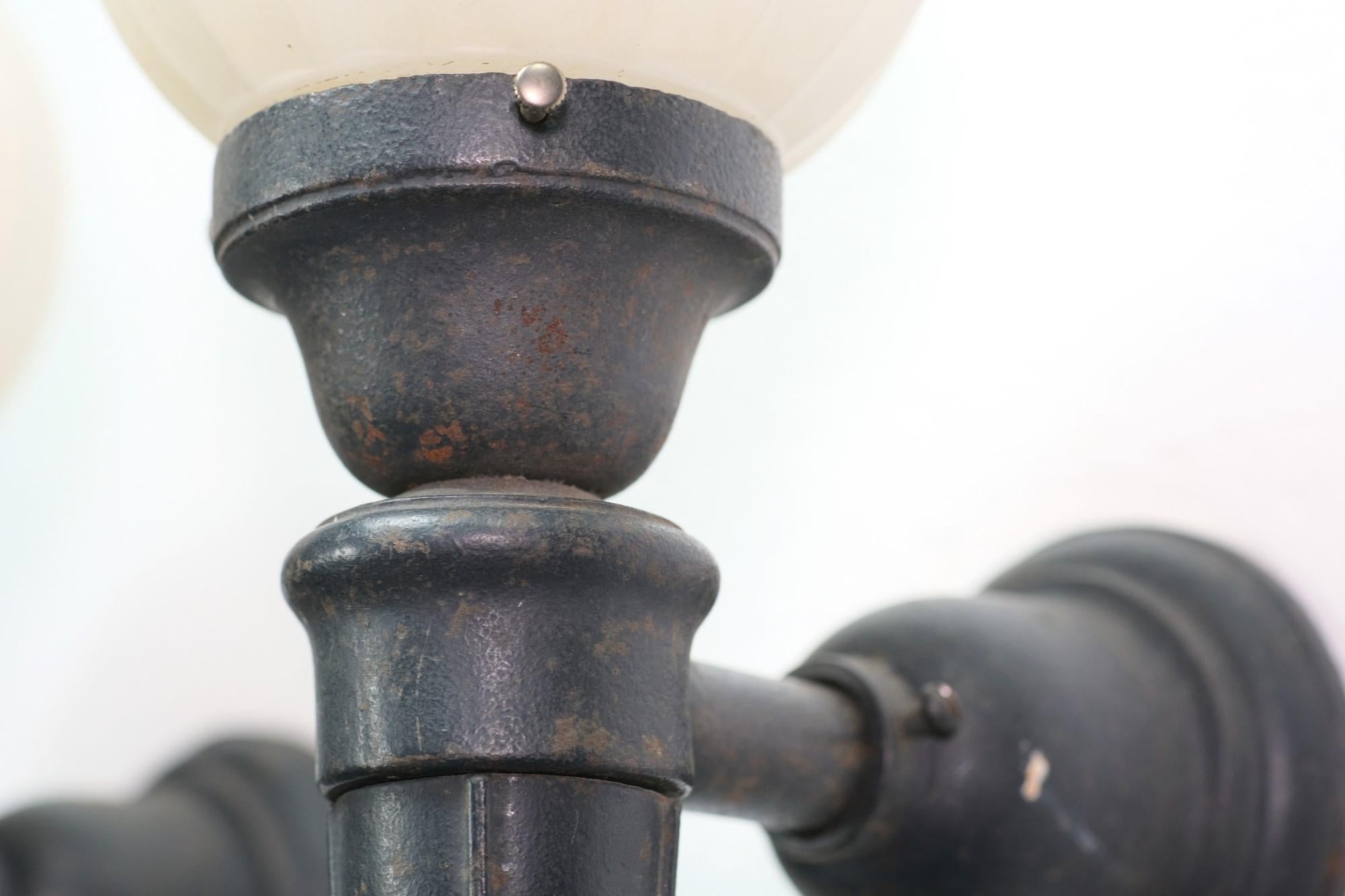 American 1920s Exterior Black Cast Iron Sconces with Round Fluted & Frosted Glass Globes 