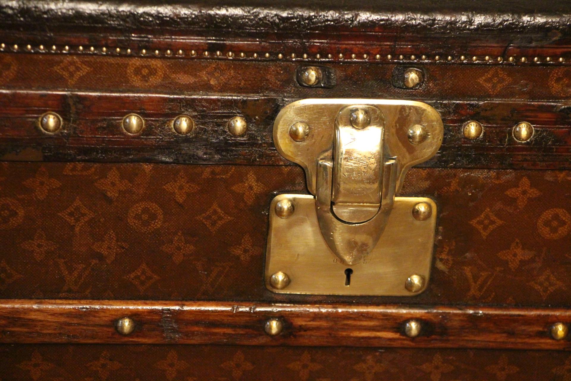 Extra large Louis Vuitton steamer trunk featuring monogram canvas, leather trim, stamped LV brass locks, stamped LV brass locks, brass corners and stamped LV studs. It has got a beautiful and warm patina. Painted French flag on each side. Very warm