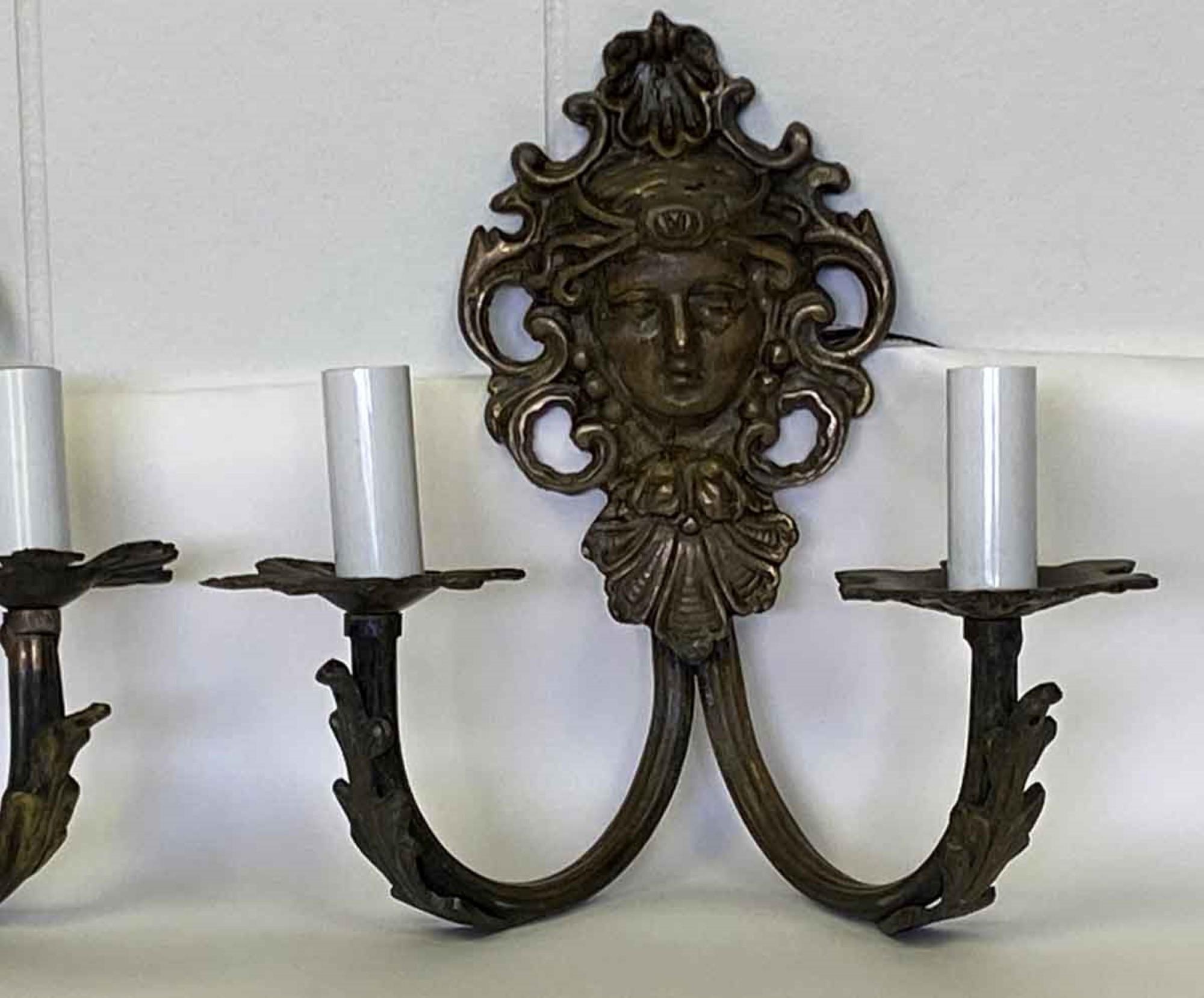 1920s cast bronze figural theater sconces with lady faces. Faces have variations. These can be restores with crystals for an additional cost. Price is per pair. Small quantity available at time of posting. Please inquire. This can be seen at our 400
