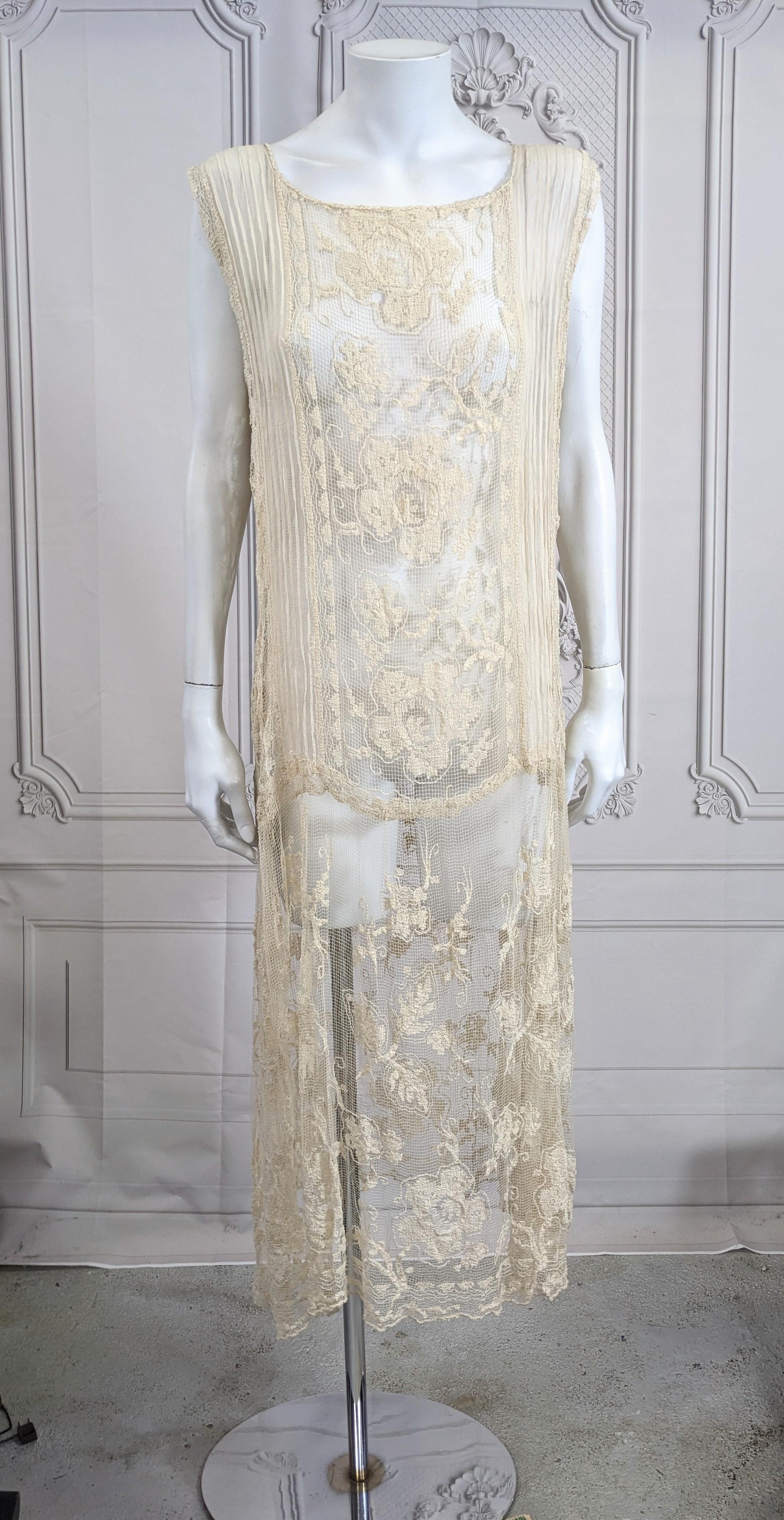 Charming Cotton Filet Lace and Chiffon Dress from the 1920's. Pin tucked silk chiffon is inserted with cotton filet lace panels and attached to a lace skirt gathered from hip. Silk knot trim embroidered neckline. Slip over style. Sheer needs slip.