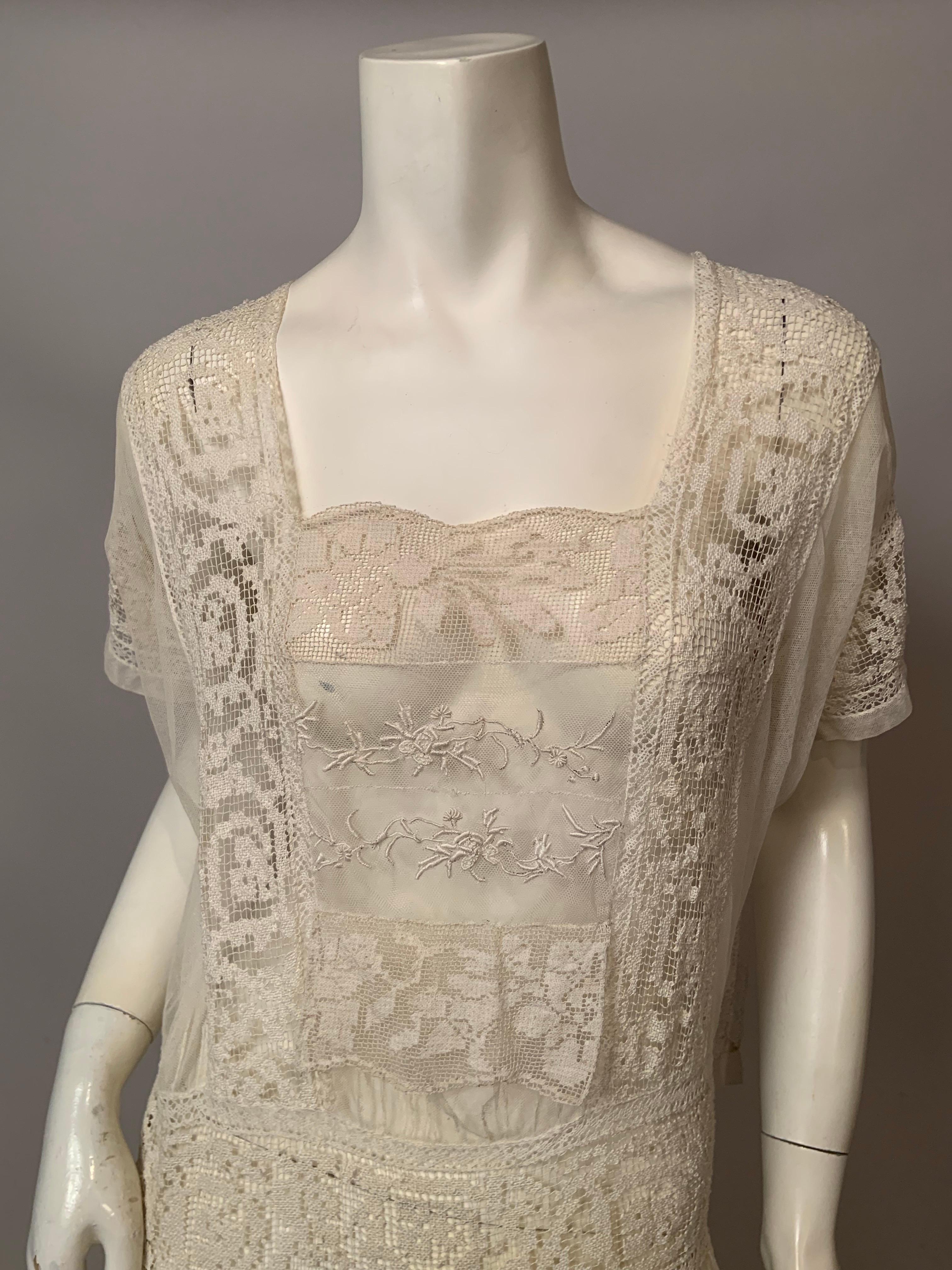 This 1920's filet lace dress was Made in France and it is a very beautiful and wearable dress. It has a square neckline with two small hand embroidered panels at the center front. The dropped waist has snaps at the left side and the skirt is made of