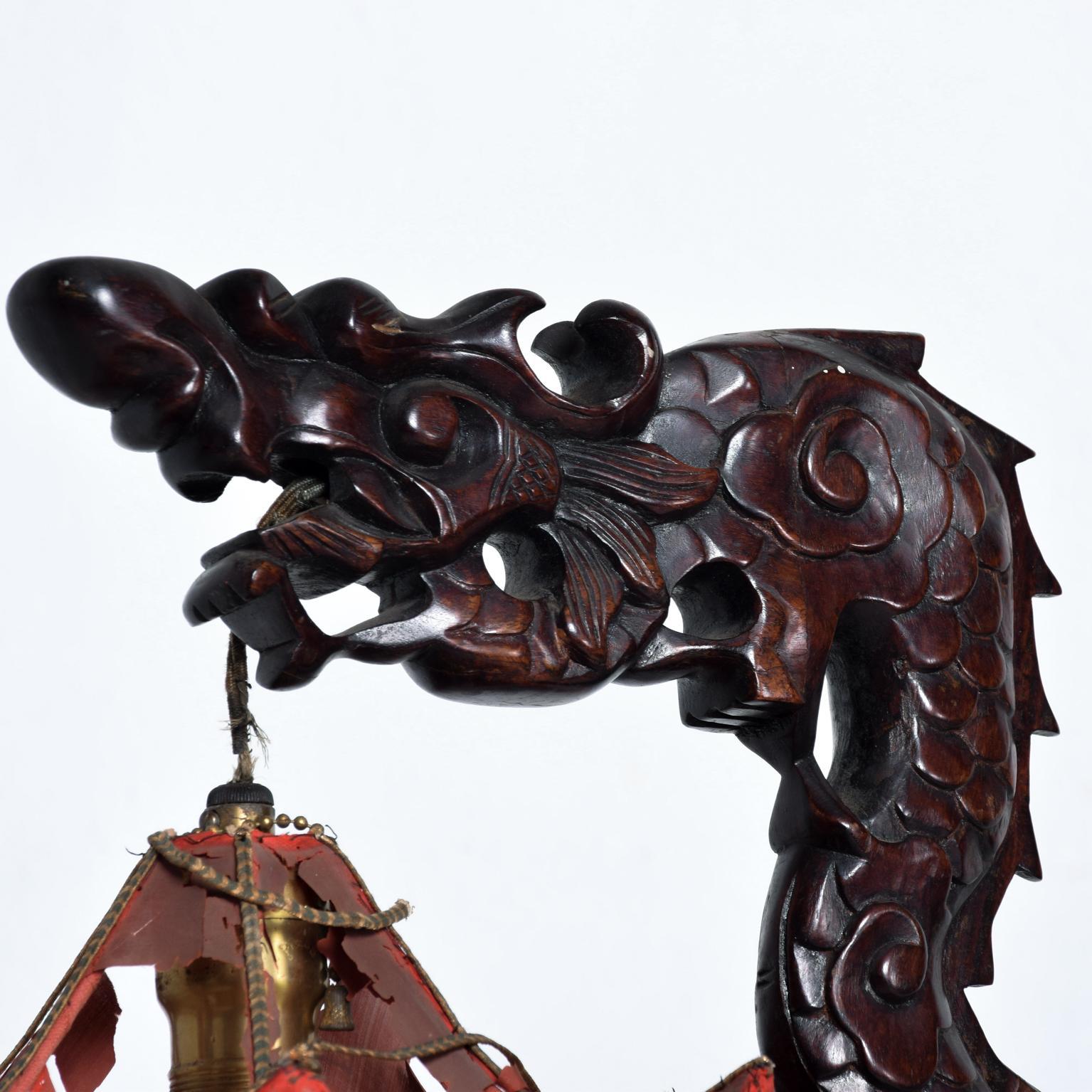 For your consideration an antique table lamp. Hand carved dragon sculpture in solid rosewood with original pagoda shade. China circa the 1920s. Dimensions: 26 1/2