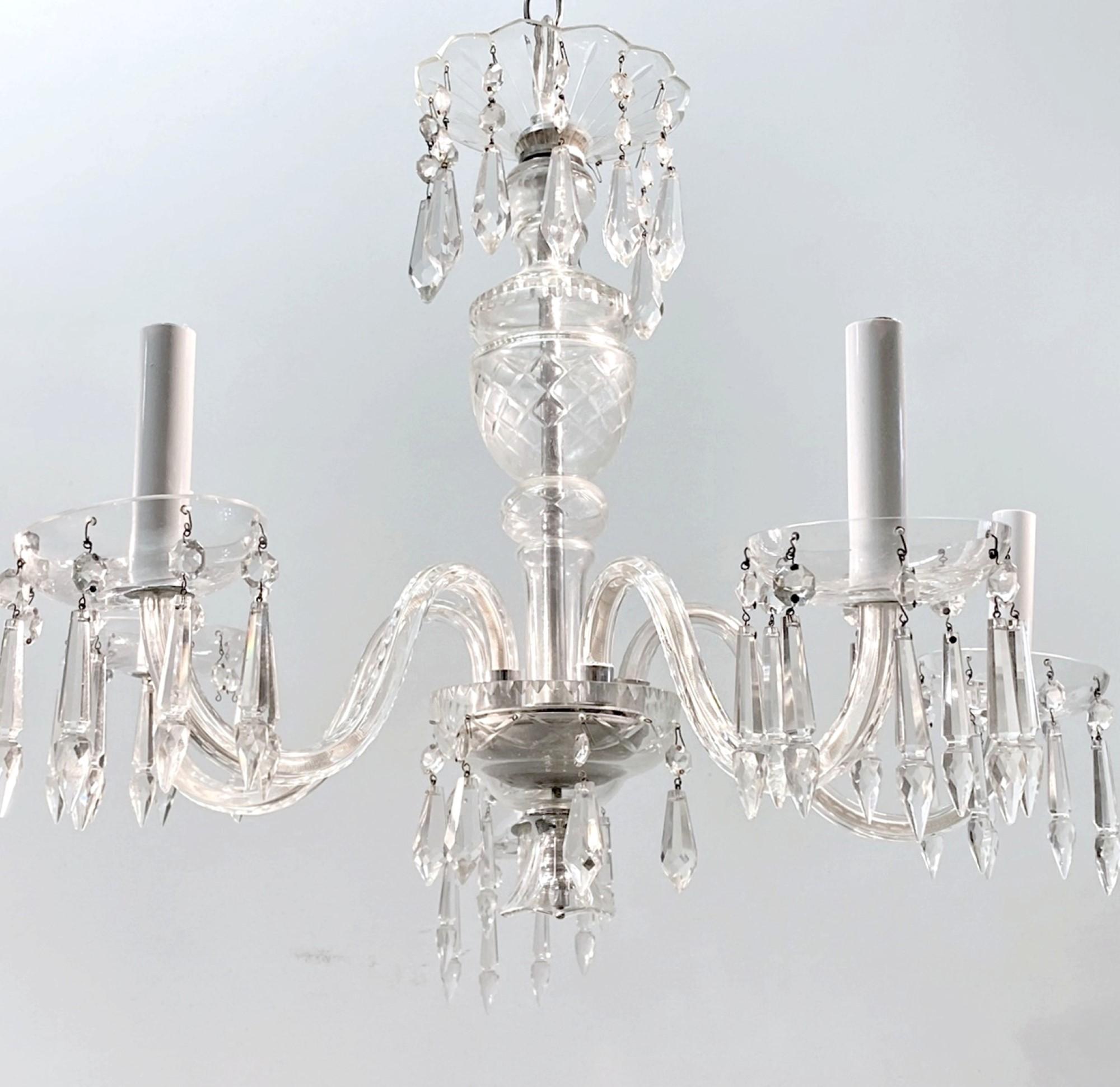 1920s five-arm clear crystal chandelier featuring sags of crystal. This can be seen at our 400 Gilligan St location in Scranton, PA.