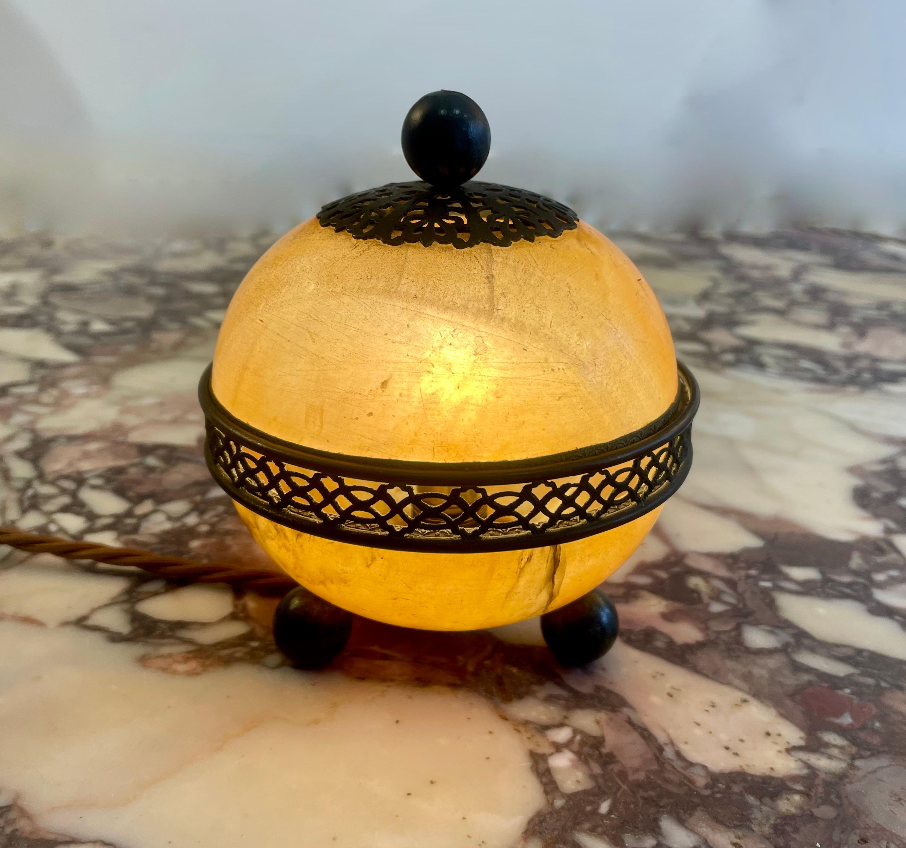 An Exquisite 1920s Art Deco, French , alabaster and brass table light. The richness in colour and beautiful patina of the alabaster play beautifully with the brass bun feet and the most intricate carving on the metal work. This really is an