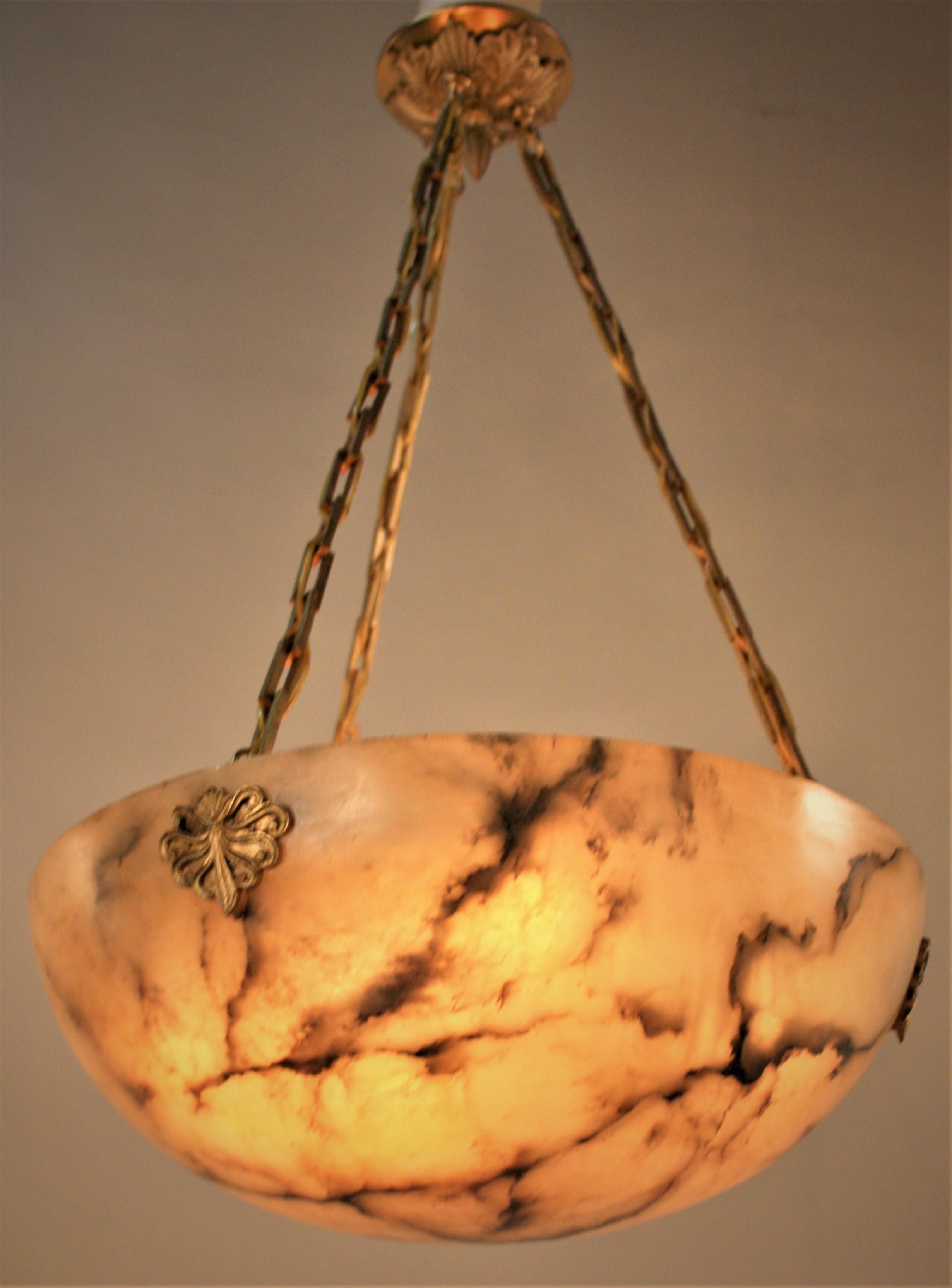 Beautiful soft color beige or cream color with black veins alabaster and bronze chandelier.