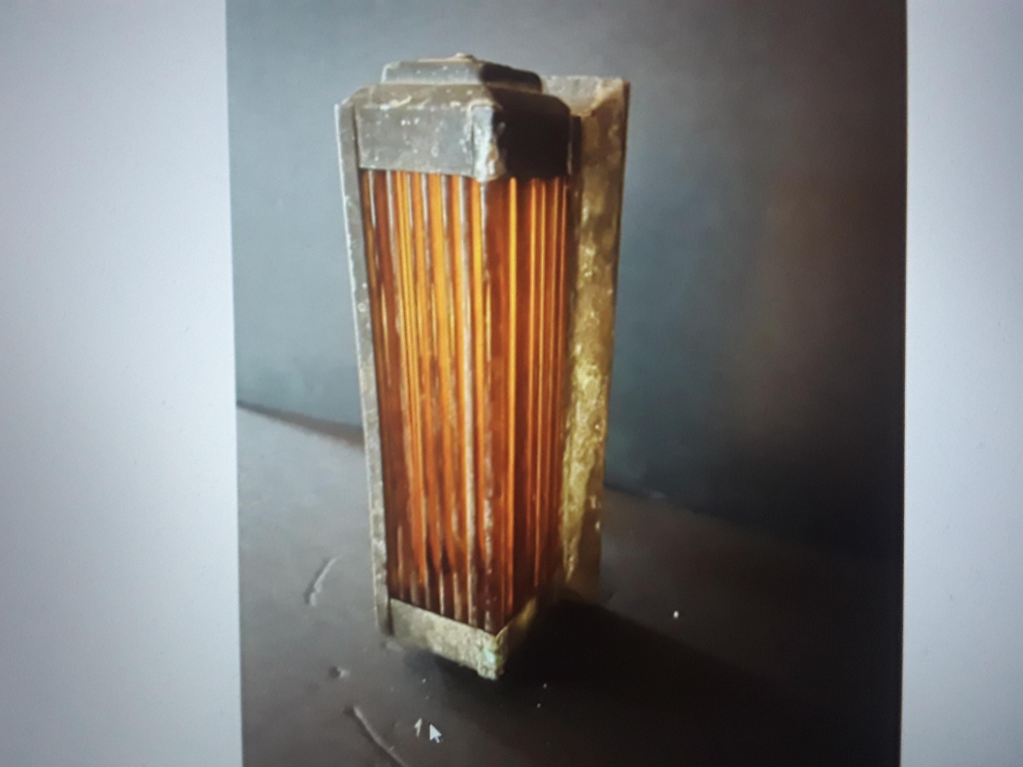 1920's French Art Deco Original Amber Glass Tube/ Brass Encased Wall Sconce. Original heavy patina. Lightly cleaned and original natural patina is present. This is an authentic period Art Deco piece of lighting and is in its original state.