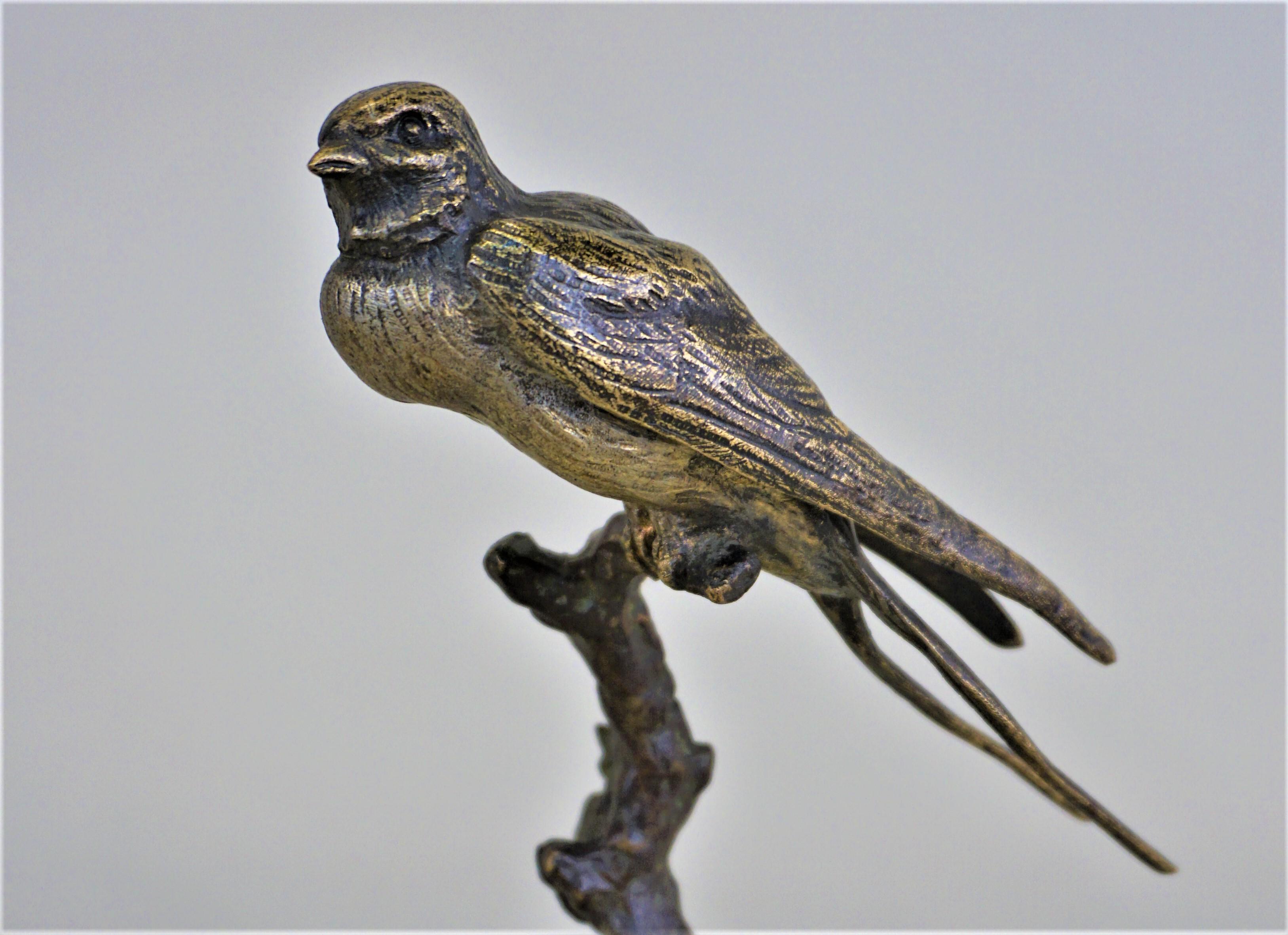 French 1920s bronze bird sitting on a tree branch.