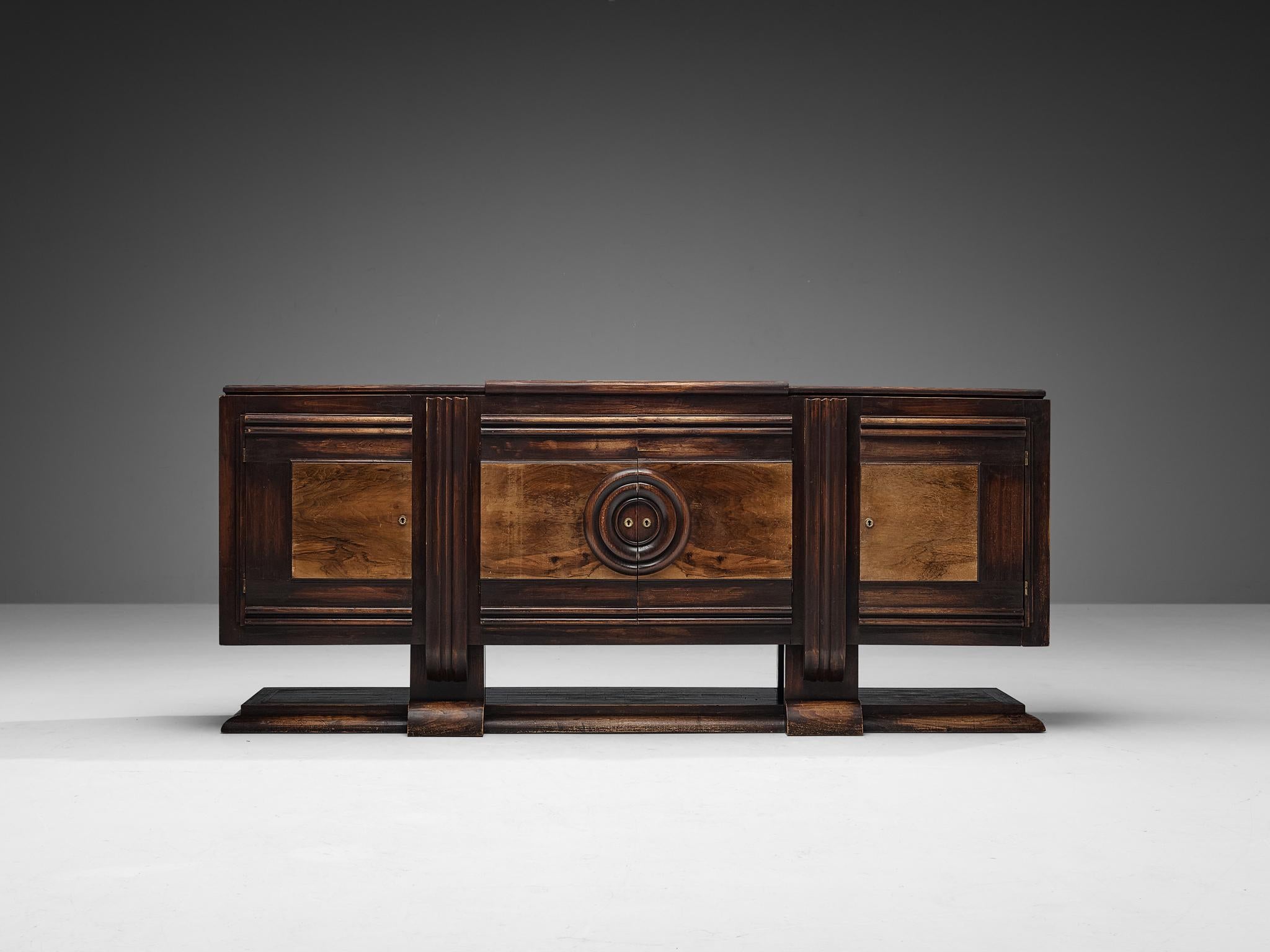 Art Deco sideboard, dark stained ash, walnut, brass, France, late 1920s. 

Antique Art Deco credenza that is definitely unique on its own way. Executed in the finest ash and walnut wood, this piece of furniture radiates quality. An intruiging