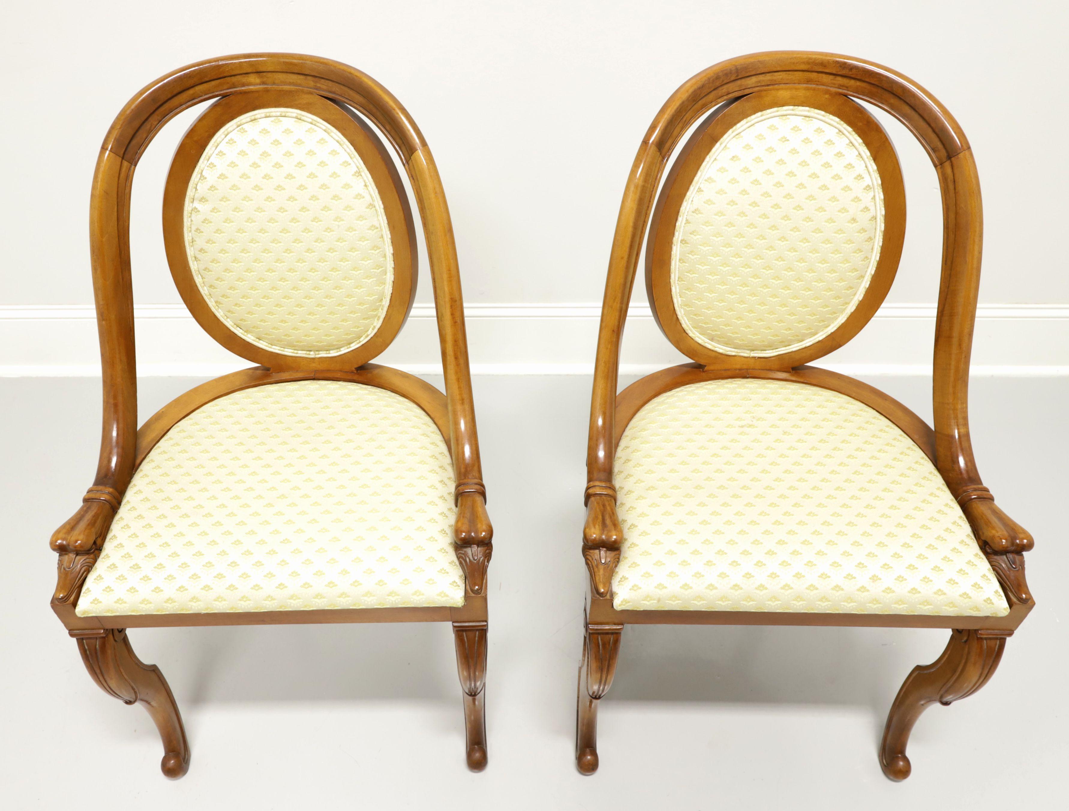 A pair of antique French Art Deco style dining side chairs, unbranded. Solid hardwood with a golden honey tone finish, rounded crestrail blending into curved stile ending with gooseheads at apron, yellow color fabric upholstered oval backrest,