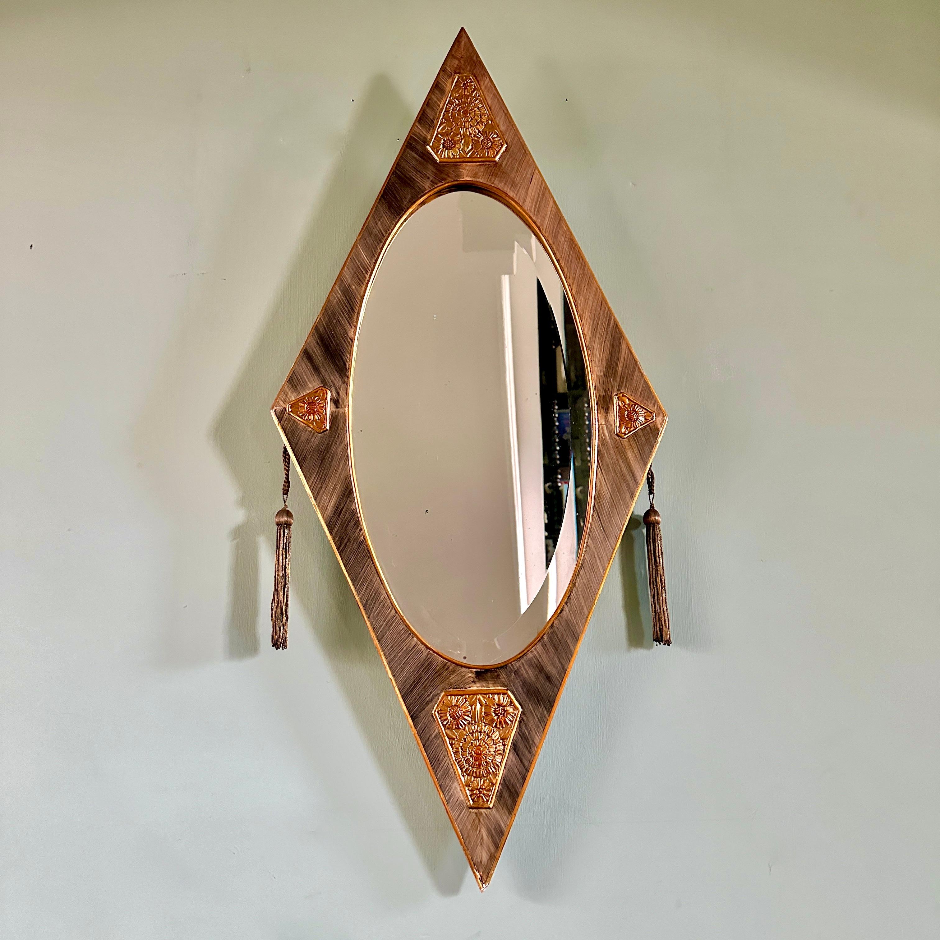 1920s French Art Deco mirror.

Superb diamond-shaped, hand-painted wood and bevelled glass mirror with gilt decorative reliefs and embroidered brass tassels. In very good condition with light and attractive wear.

Height 103cm Width 48cm 
