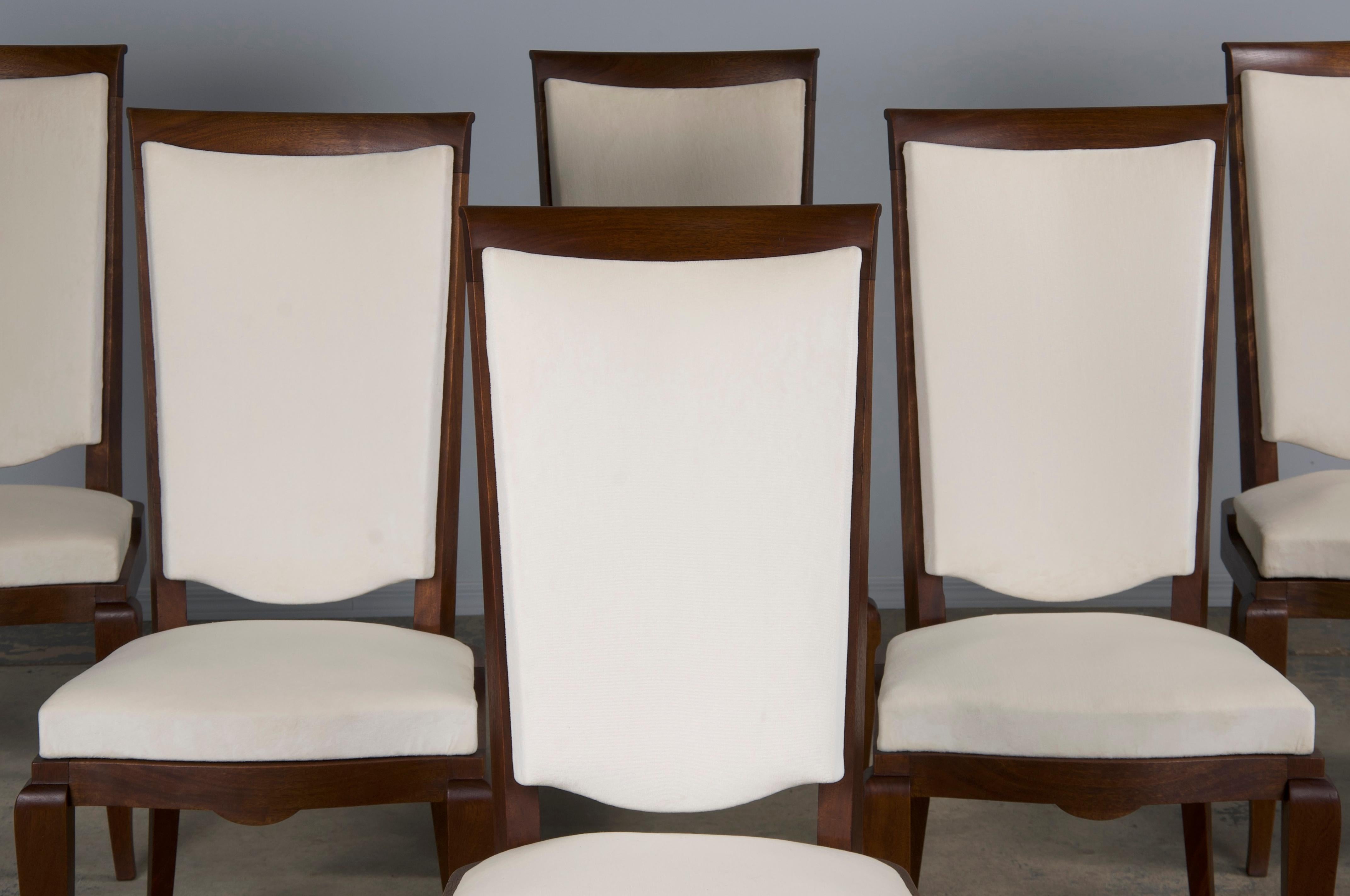 An elegant 1920s set of six French Art Deco chairs sourced from Provence, France. Beautifully hand-crafted from solid walnut wood showcasing a naturally aged patina with a rich brown color. The chairs have been structurally restored and newly