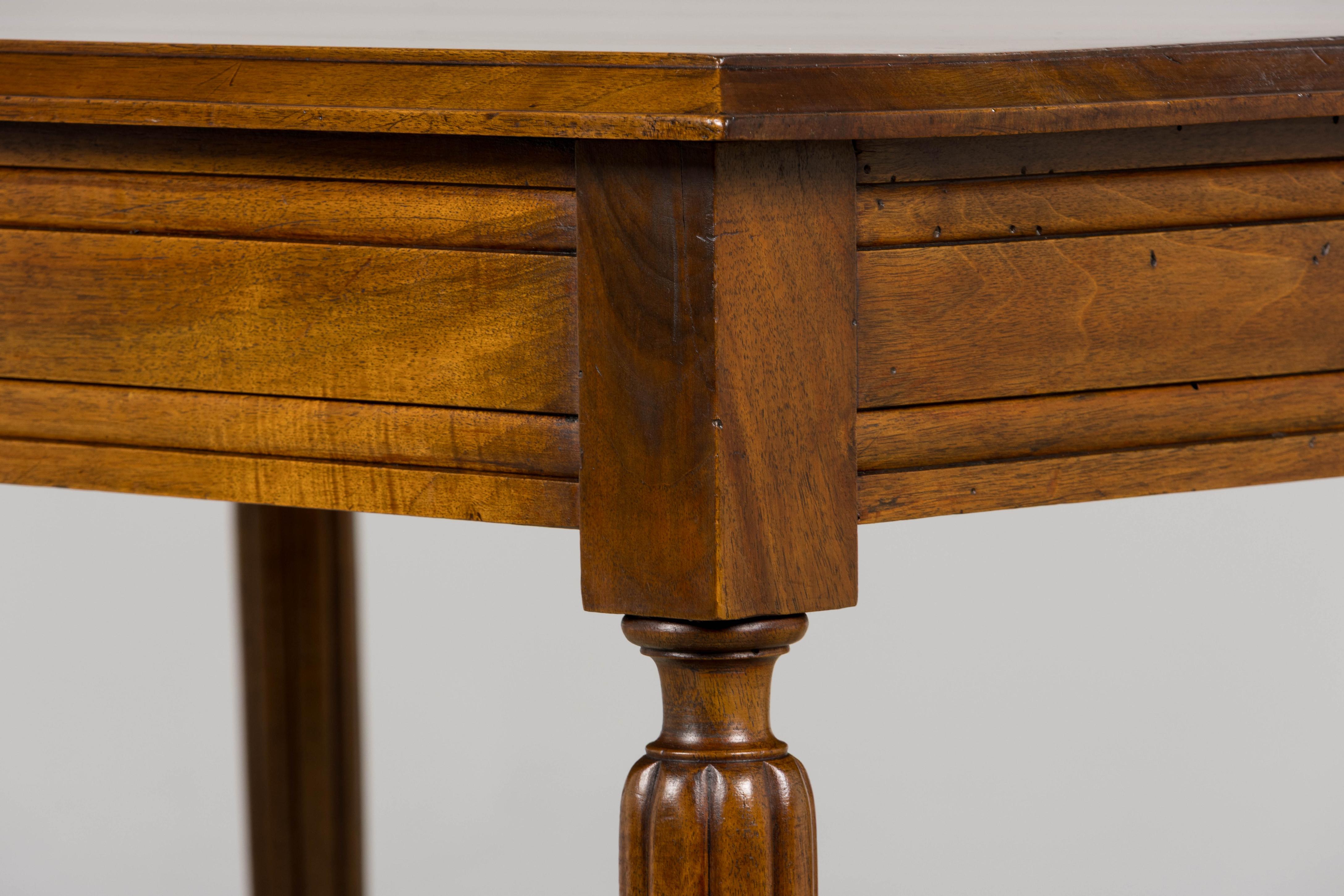 A refined 1920s French Art Deco writing table, sourced from Provence, France. Crafted from solid walnut, the table features a rectangular plank top and a clean apron detailed with subtle horizontal molding, creating a streamlined profile emblematic