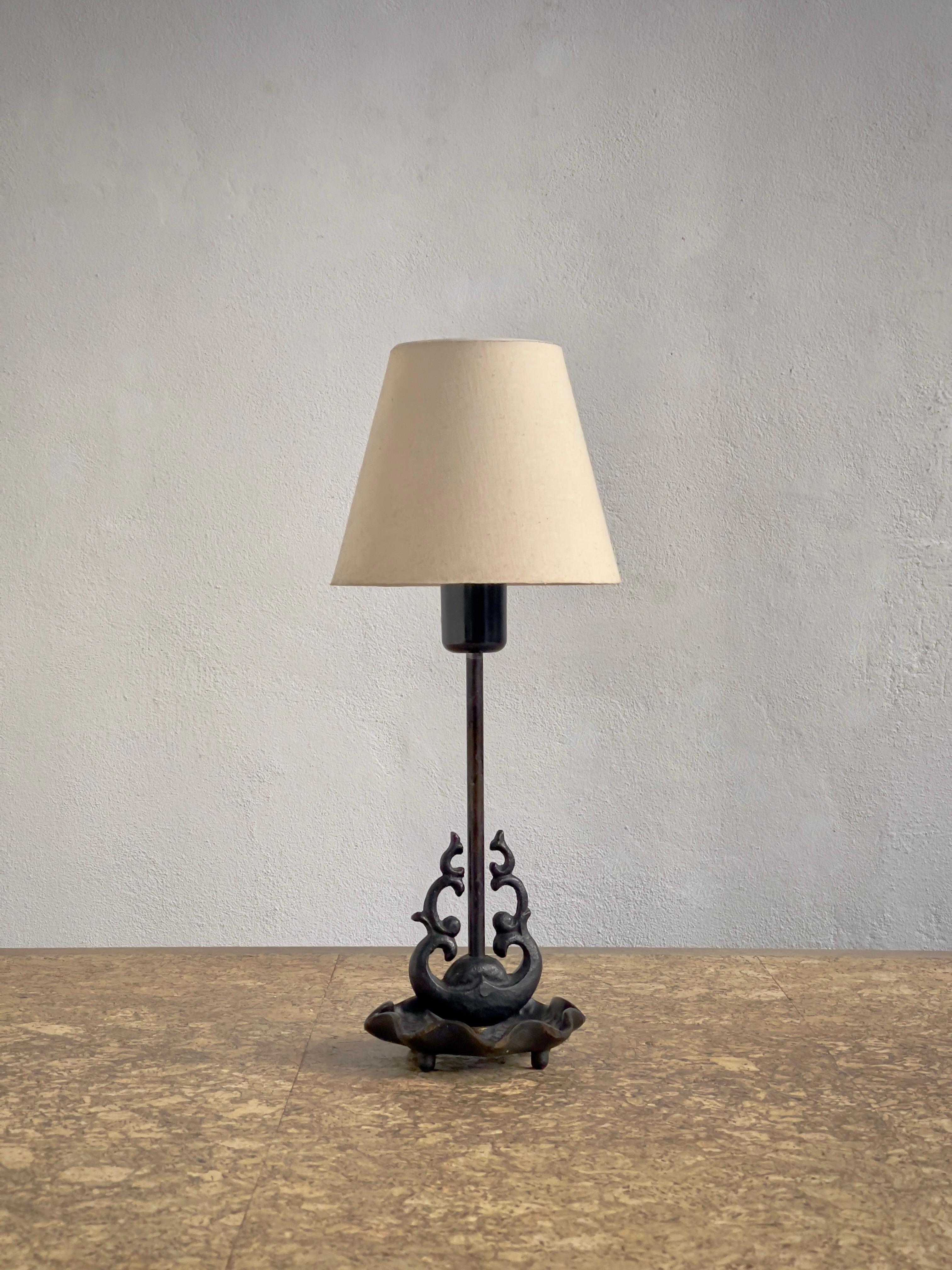 This exquisite 1920s French Art Nouveau table lamp, crafted in patinated black cast bronze, embodies the movement’s signature organic elegance and sculptural artistry. The fluid, nature-inspired lines of the bronze base evoke the sinuous forms