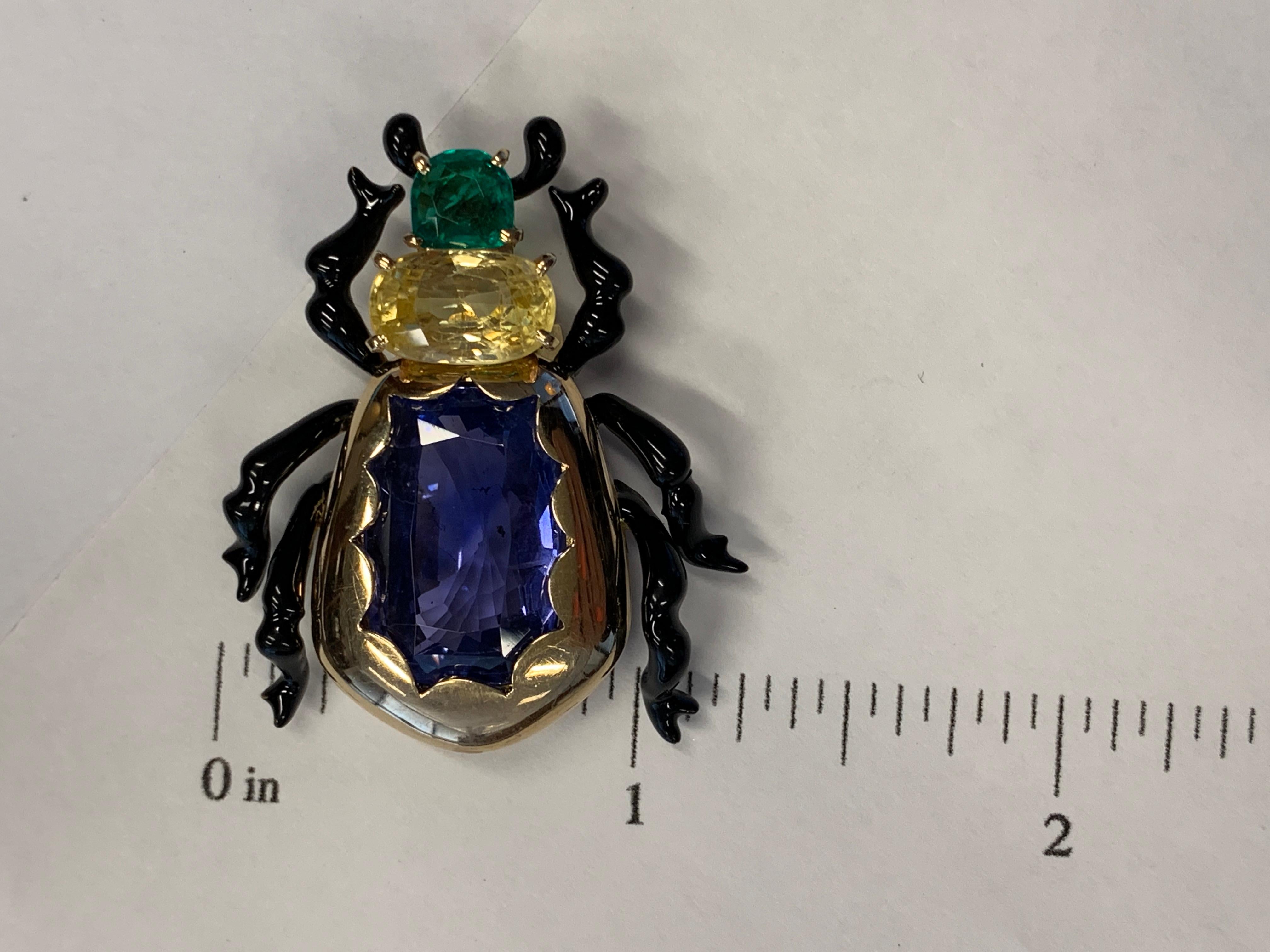 18kt Gold, Enamel, Sapphire, & emerald beetle clip,. Set with 1 approx. 16.00 carat blue sapphire, 4.40 yellow sapphire, and .51 carat emerald. French marks.