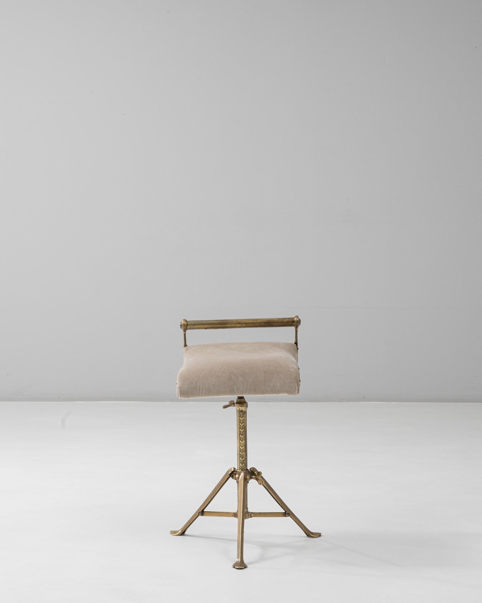 This 1920s French brass adjustable stool combines industrial ingenuity with refined Art Deco detailing. The sculpted tripod base features engraved foliate motifs, highlighting the craftsmanship and decorative elegance of early 20th-century French