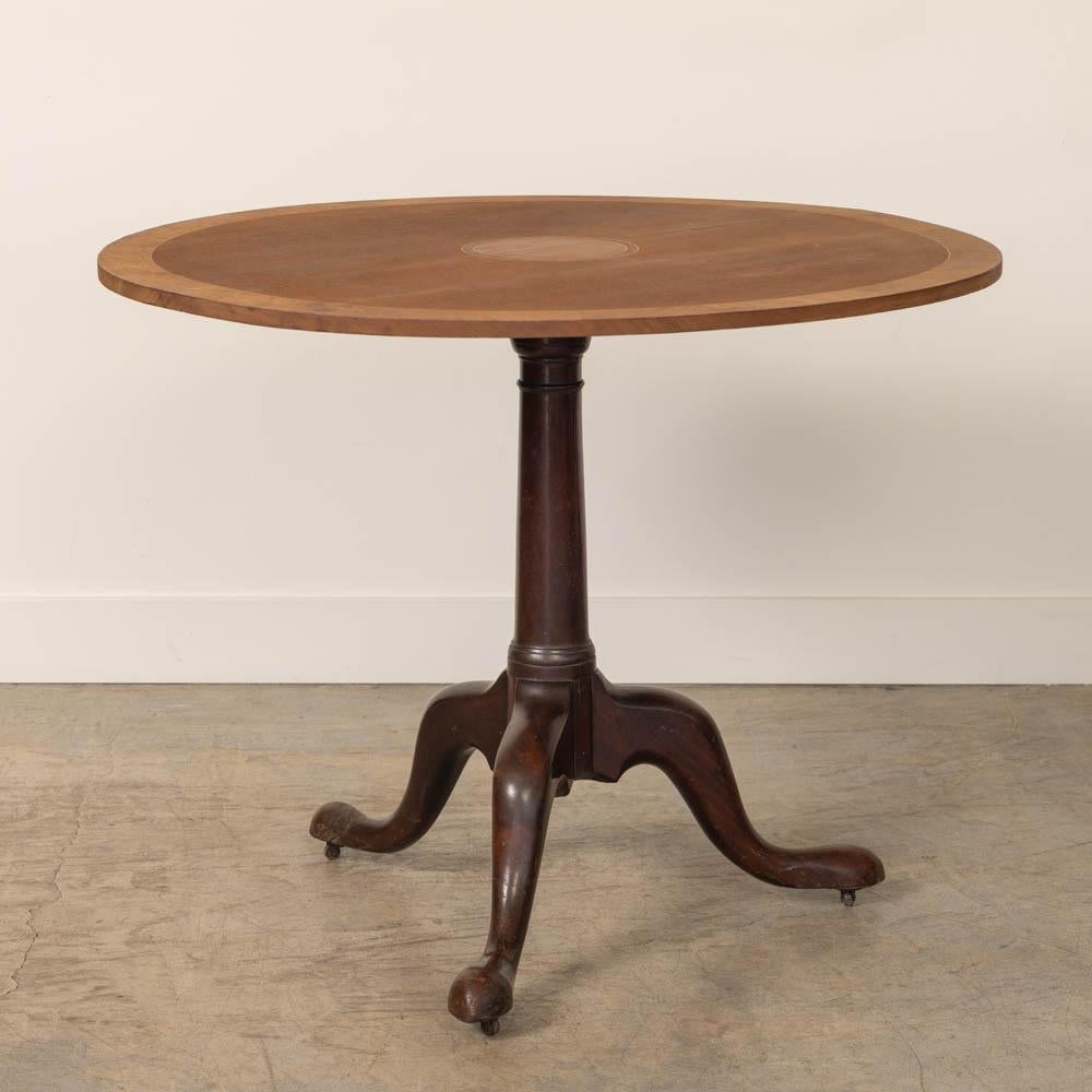Great folding table from France, 1920s. Beautiful wood top with burl inlay and three sculptural carved wood legs. Unique folding detail allows for easy storage. Perfect as a center table or game table. Original finish shows nice age and patina.