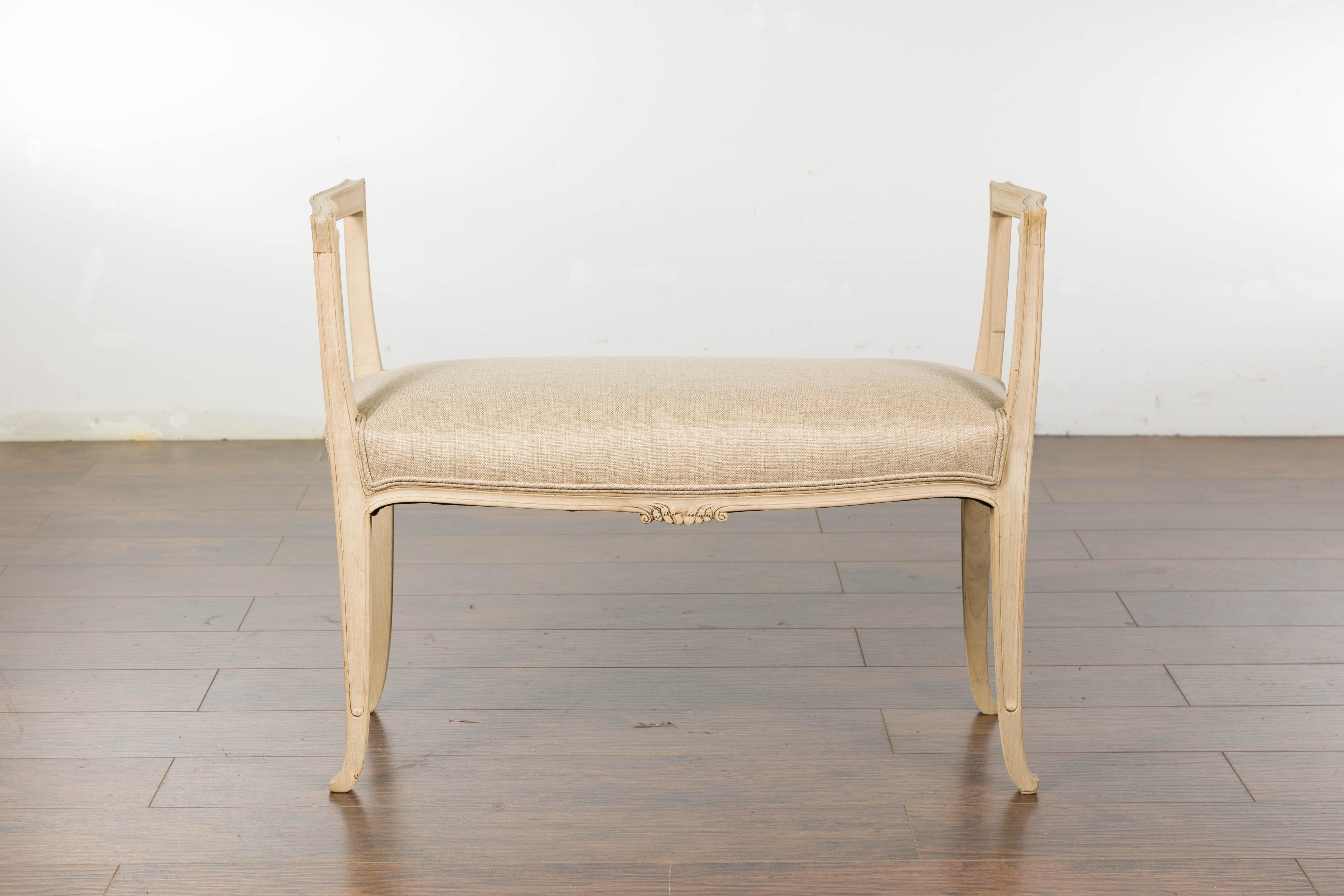 A small French walnut bench from circa 1920 with delicately carved motifs and upholstered seat. Embrace the charm of 1920s France with this exquisite small French walnut bench, a perfect embodiment of timeless elegance and tasteful design. 

The