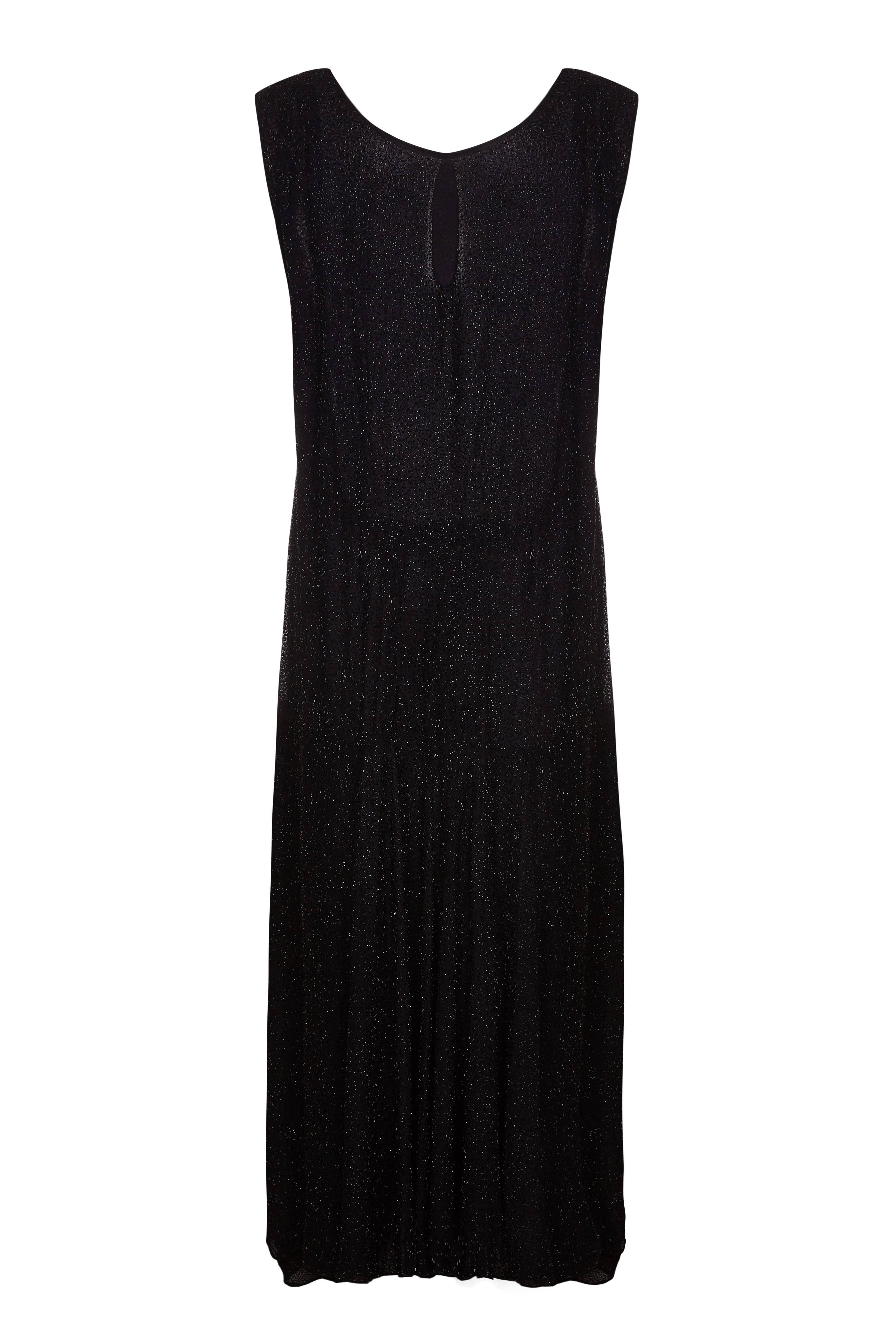 Beautiful original vintage and wearable 1920s black flapper dress completely covered in tiny black beads.  The dress is slightly flared in the skirt and features a peep hole at the back of the neckline and two ties that fall to the front which can