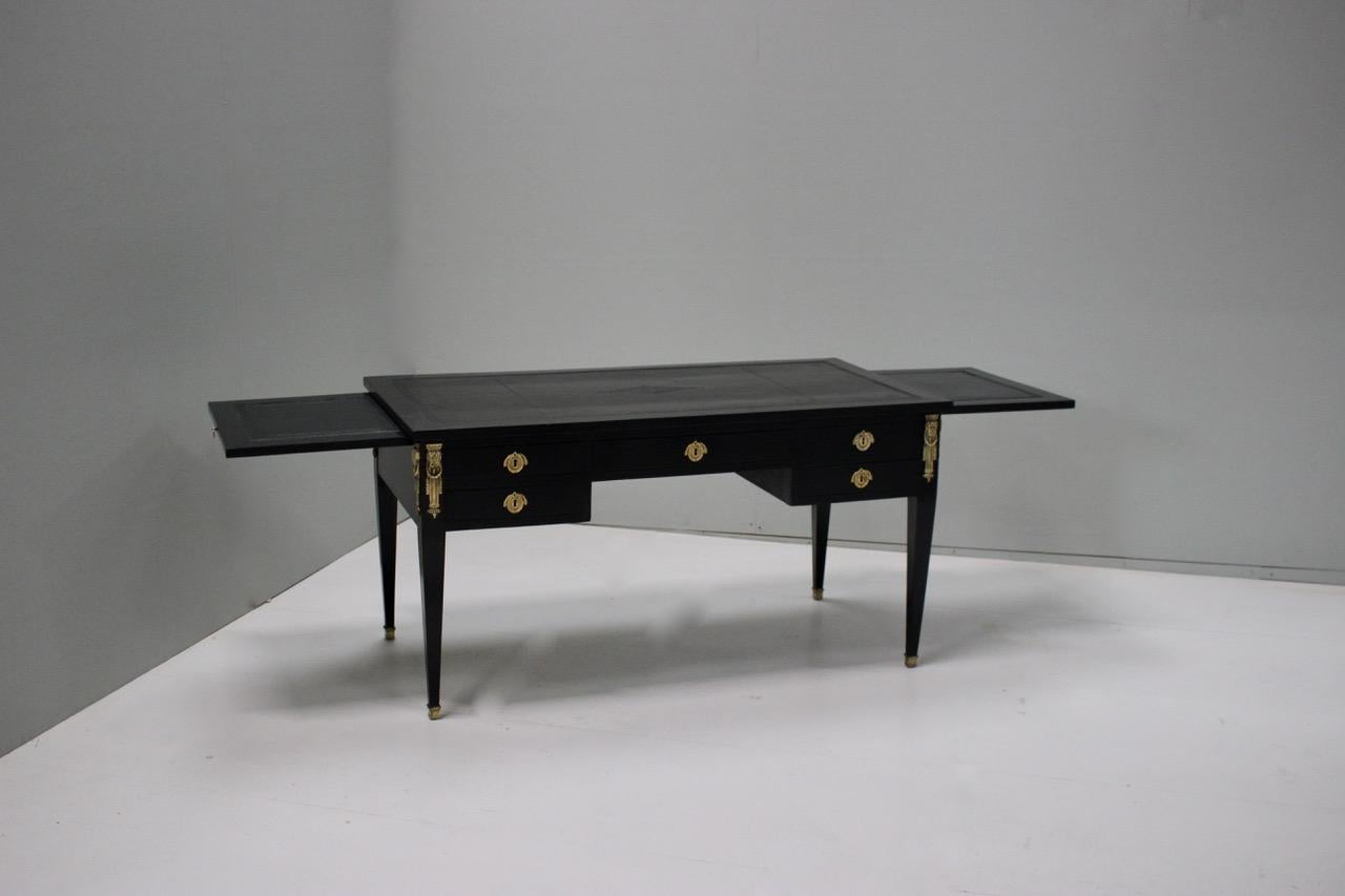 A good quality and of elegant proportions, circa 1920s French ebonized desk in the Louis XVI taste, with two brushing slides, that will work well in most settings.
Additional measurements:
Knee height 57.5 cm x fully open 211cm wide.