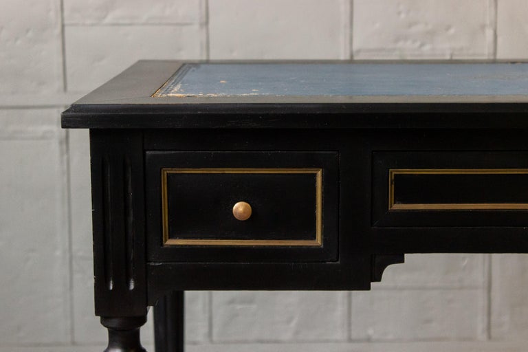 Early 20th century writing desk with three drawers. Ebonized Mahogany with original (distressed) leather. Sold as is.


