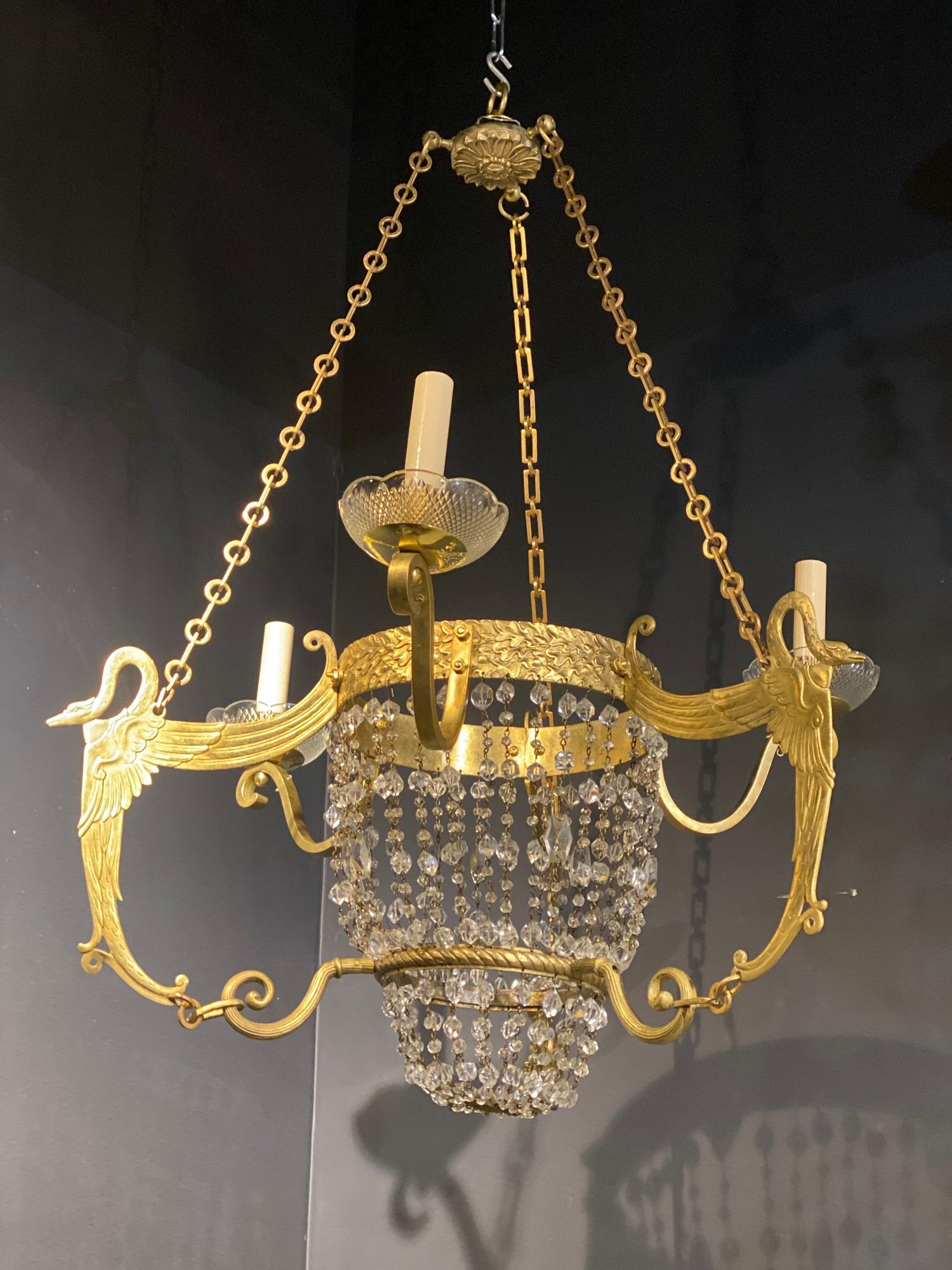 A circa 1920’s French Empire three lights chandelier with swans and beaded crystals
