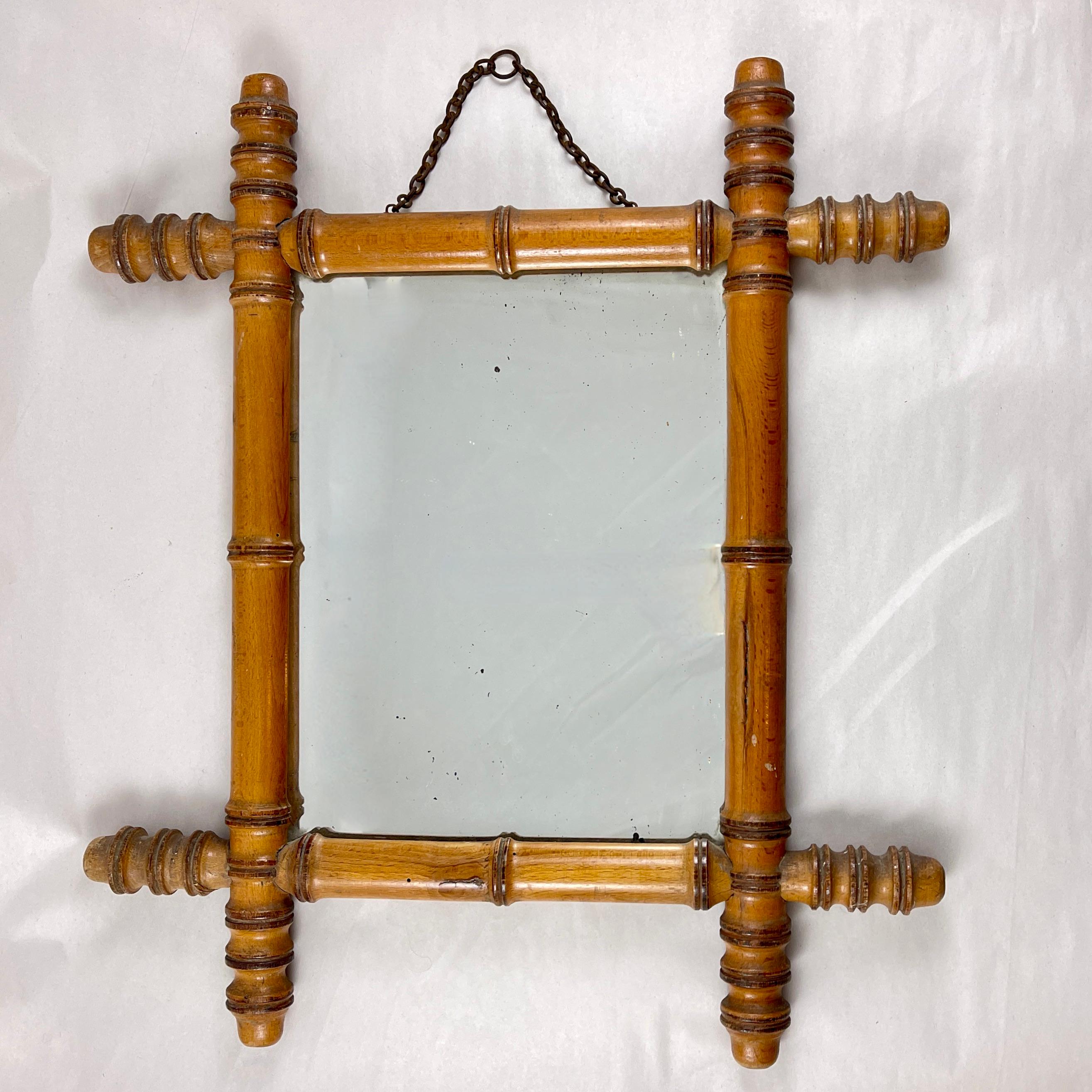 A faux bamboo wood framed mirror, France, circa 1920s.

In the Chinoiserie taste, a hard-wood frame formed to resemble bamboo. With the original mirror and metal hanging chain. Backed with the original thin sheet of wood as well. Heavy.

Most often