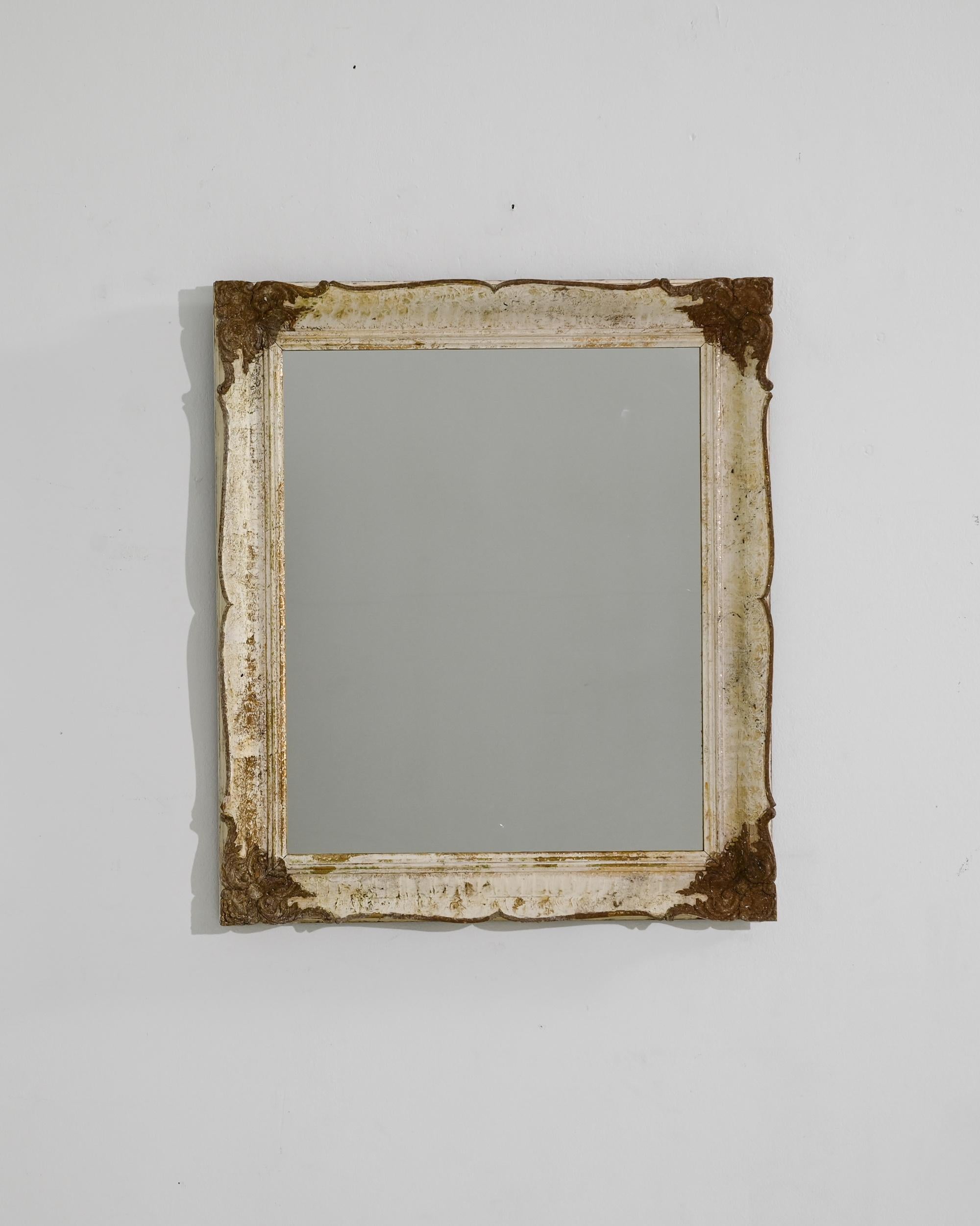 Mirror mirror, this enchanting antique was crafted in France, circa 1920. Made to reflect the fairest, this magic mirror tells the story of life in another era. Profiled edges were carved by hand, lending a refined expression to the minimal shape;