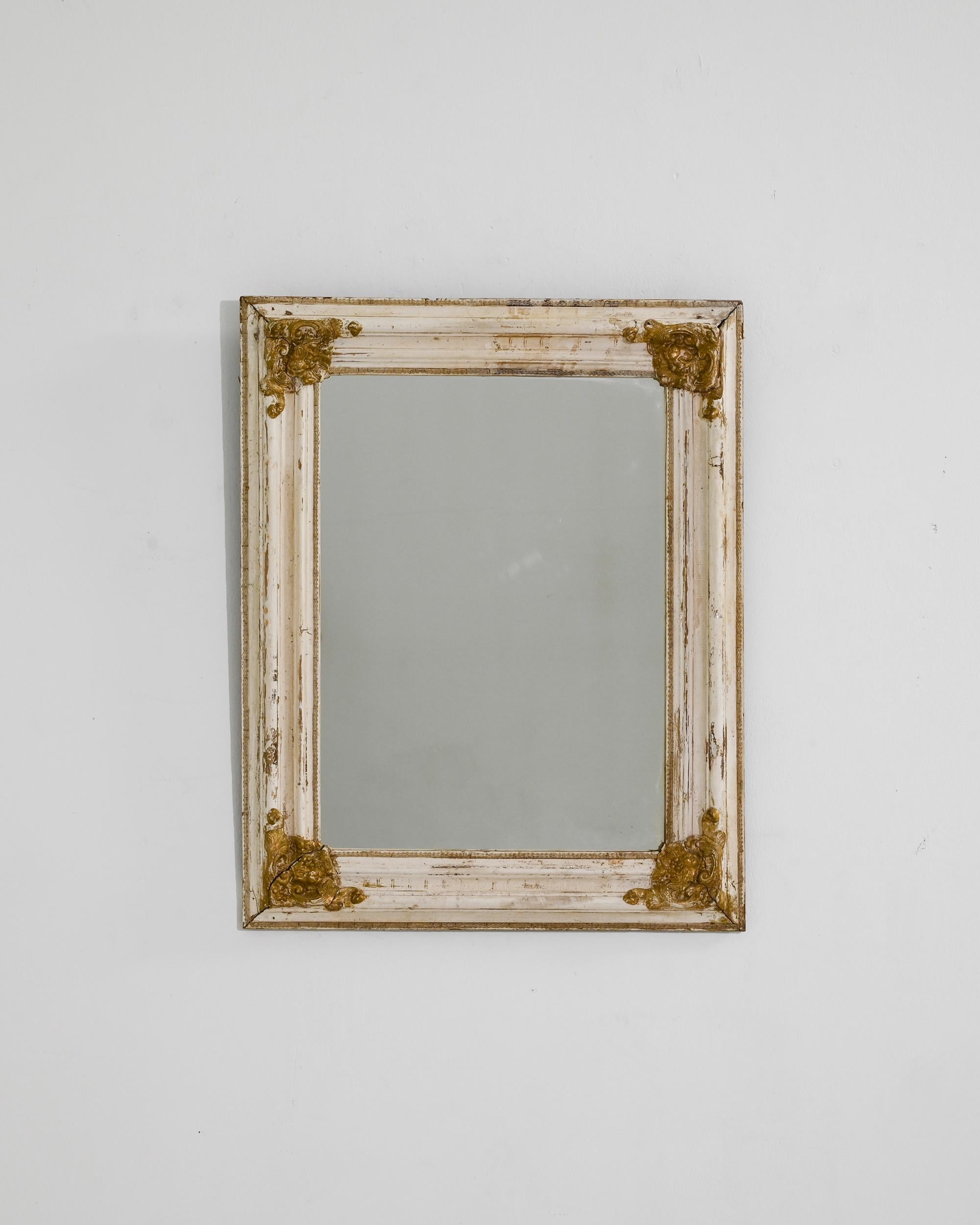 Mirror mirror, this enchanting antique was crafted in France, circa 1920. Made to reflect the fairest, this magic mirror tells the story of life in another era. Profiled edges were carved by hand, lending a refined expression to the minimal shape;