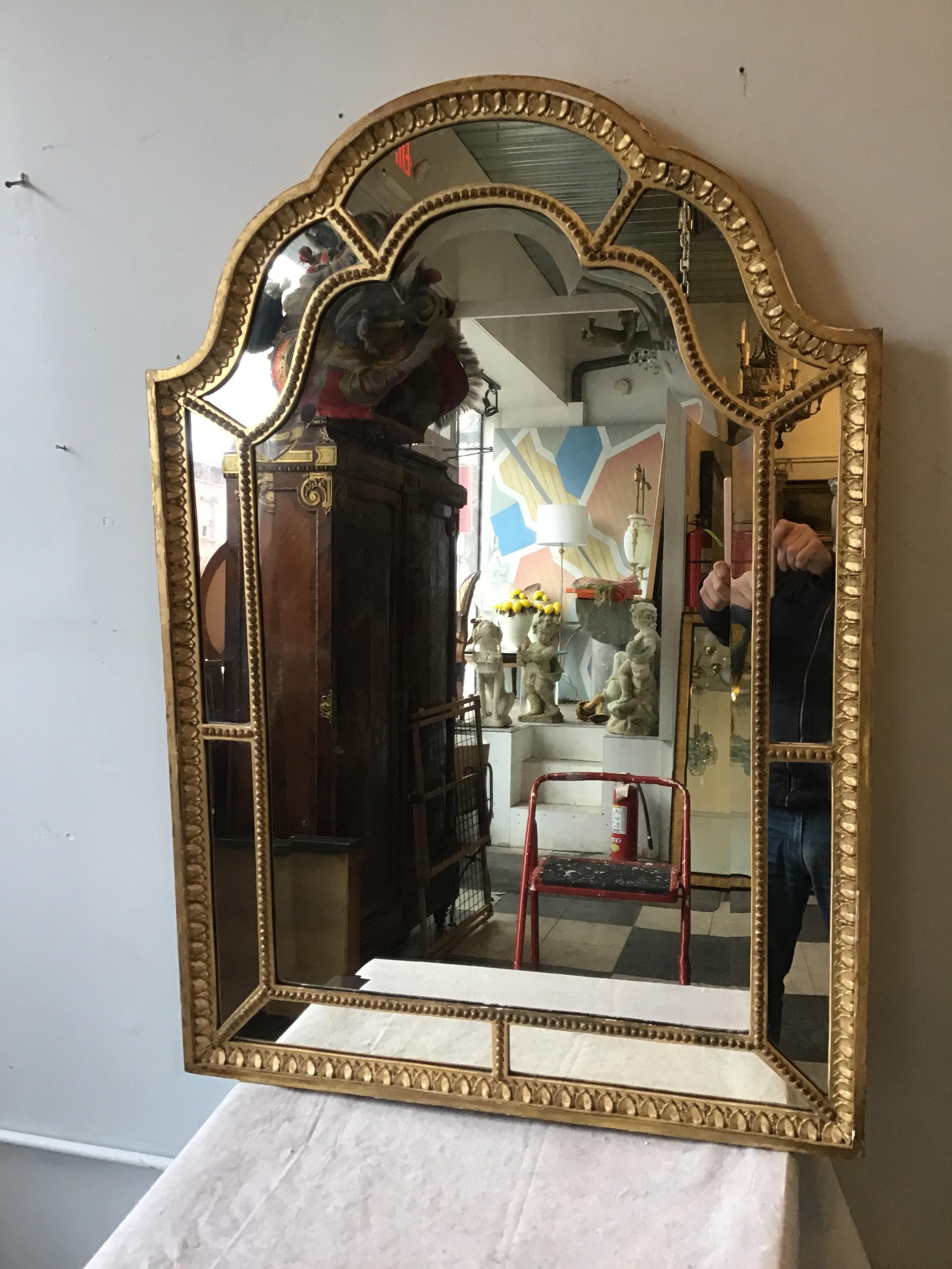1920s French giltwood beveled mirror.