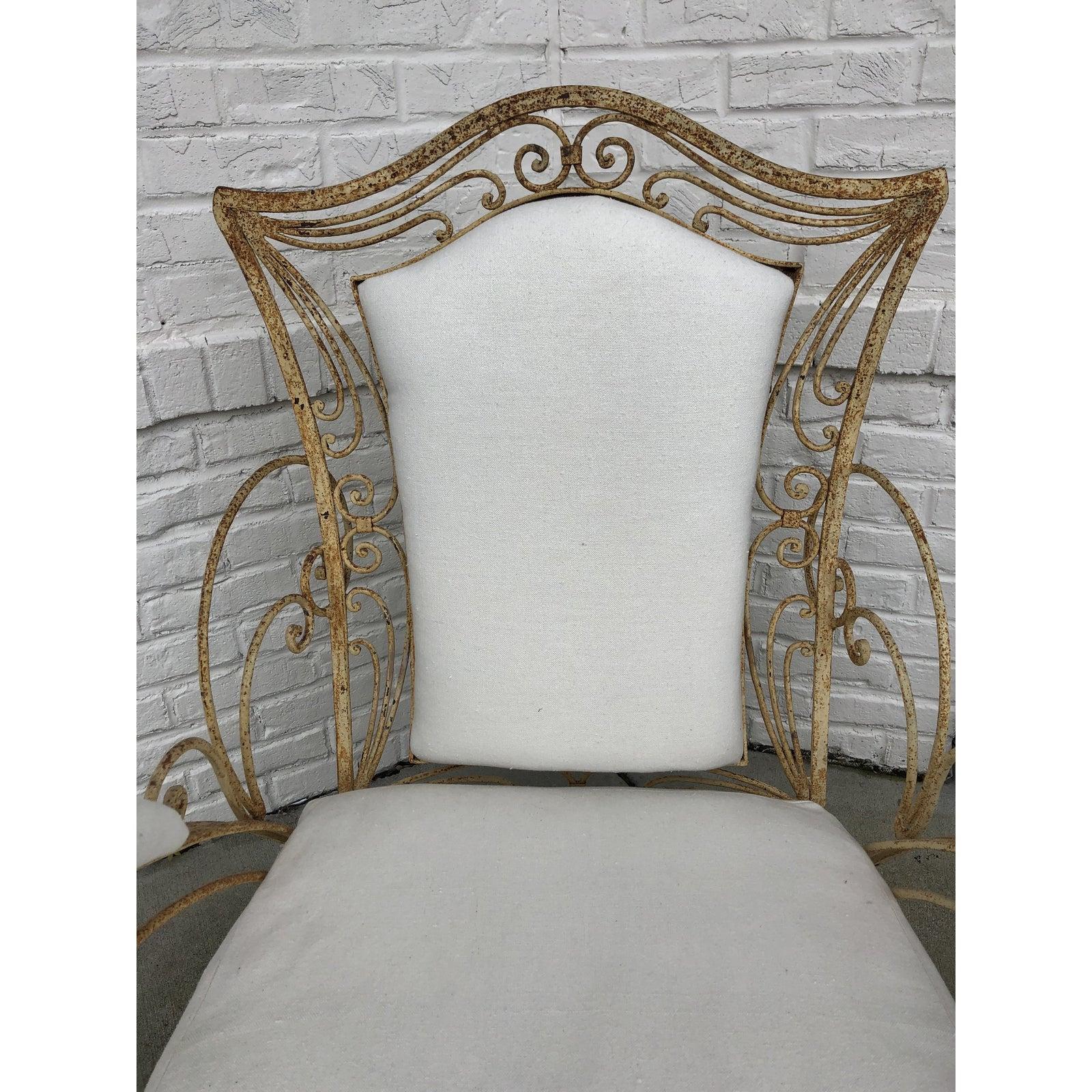 2 available!

1920's French iron garden chair. The cream colored iron has been distressed beautifully. Bent into a swirl design on the backrest and on the sides of the armrest, these chairs will fit beautifully into a terrace or enclosed