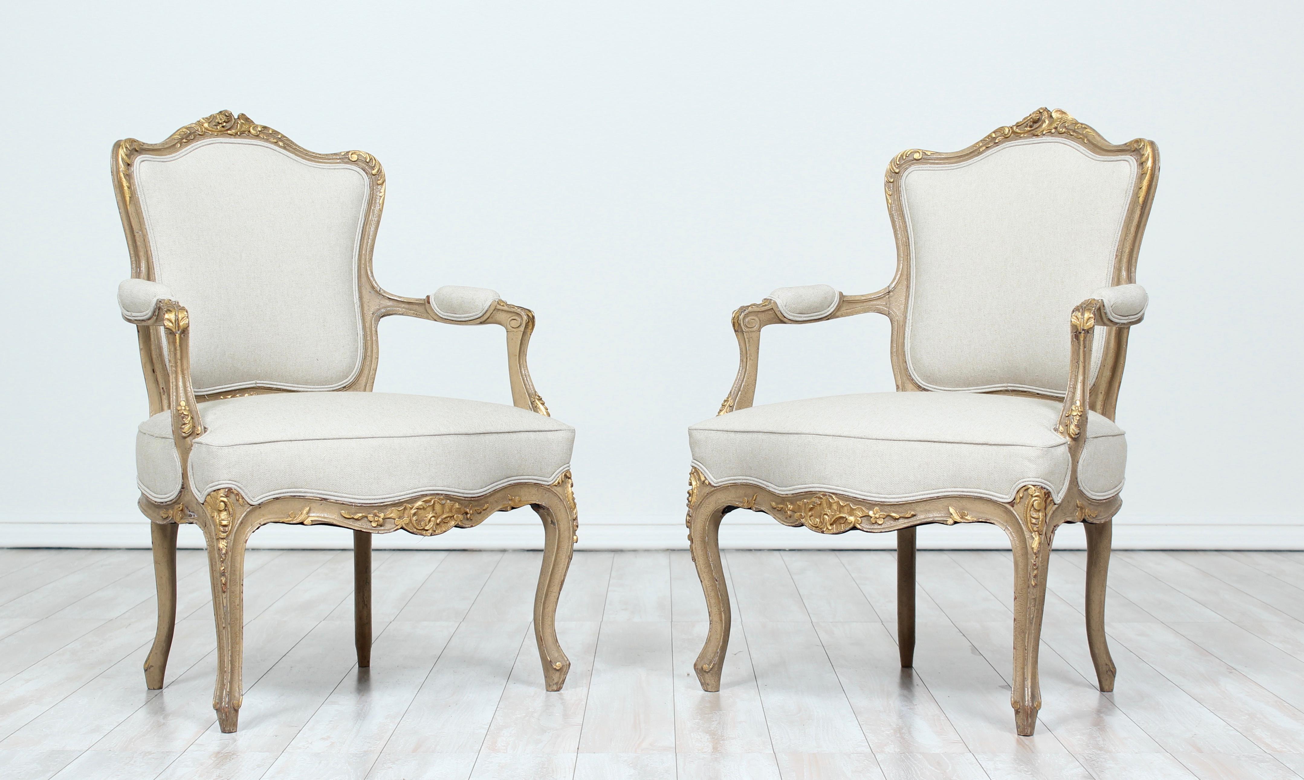 Beautiful, 1920s petite-scale French Louis XV-style painted and parcel-gilt fauteuils with delicately carved rocaille, floral and angel wing decorations. New linen canvas upholstery.    

These beautiful chairs are perfect for a child’s room or any