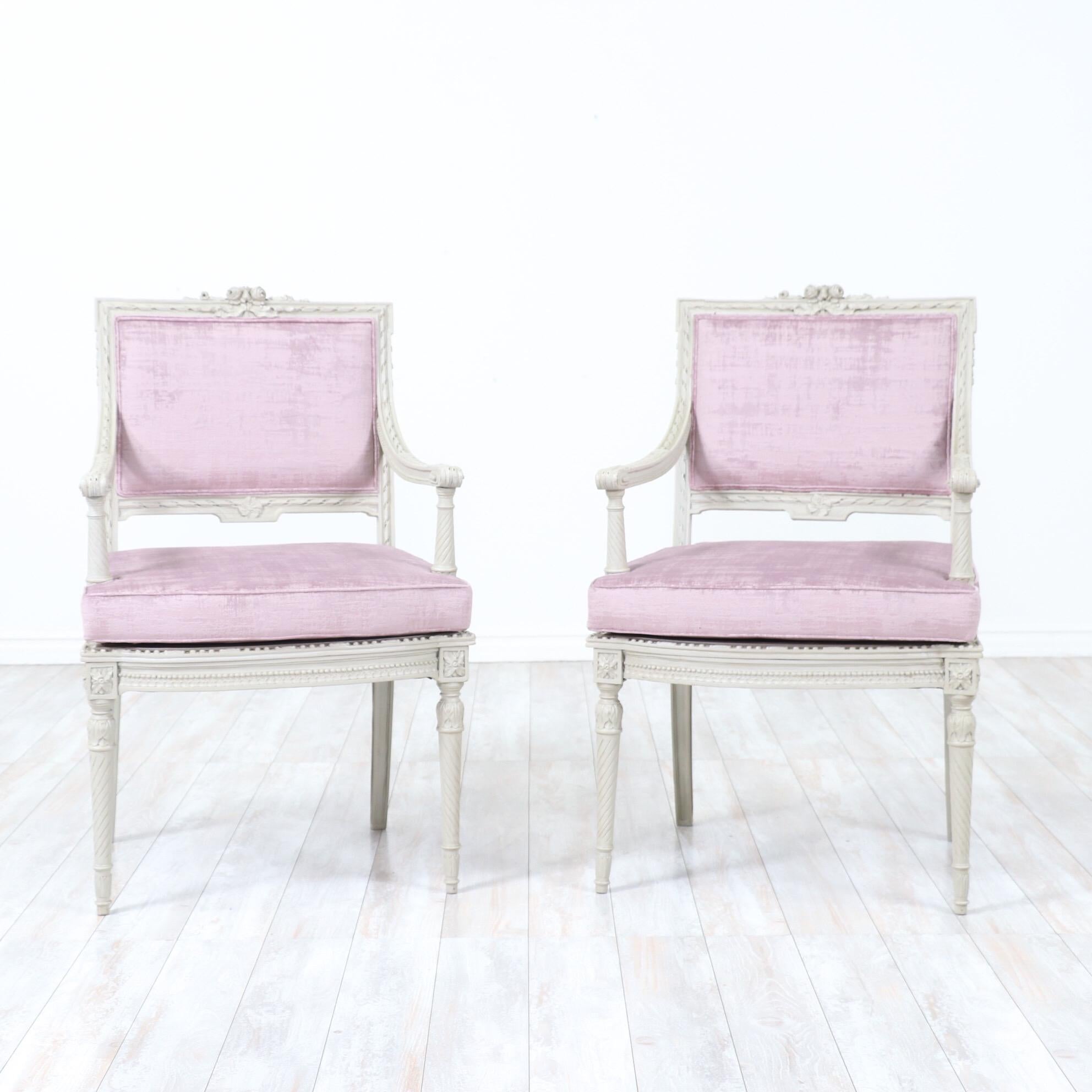 Gorgeous, French 1920s pair of armchairs in the Louis XVI style.

These beautiful chairs feature delicately carved wooden frames in a greige paint finish, new textured velvet upholstery, loose seat cushions and self welt details.

These chairs