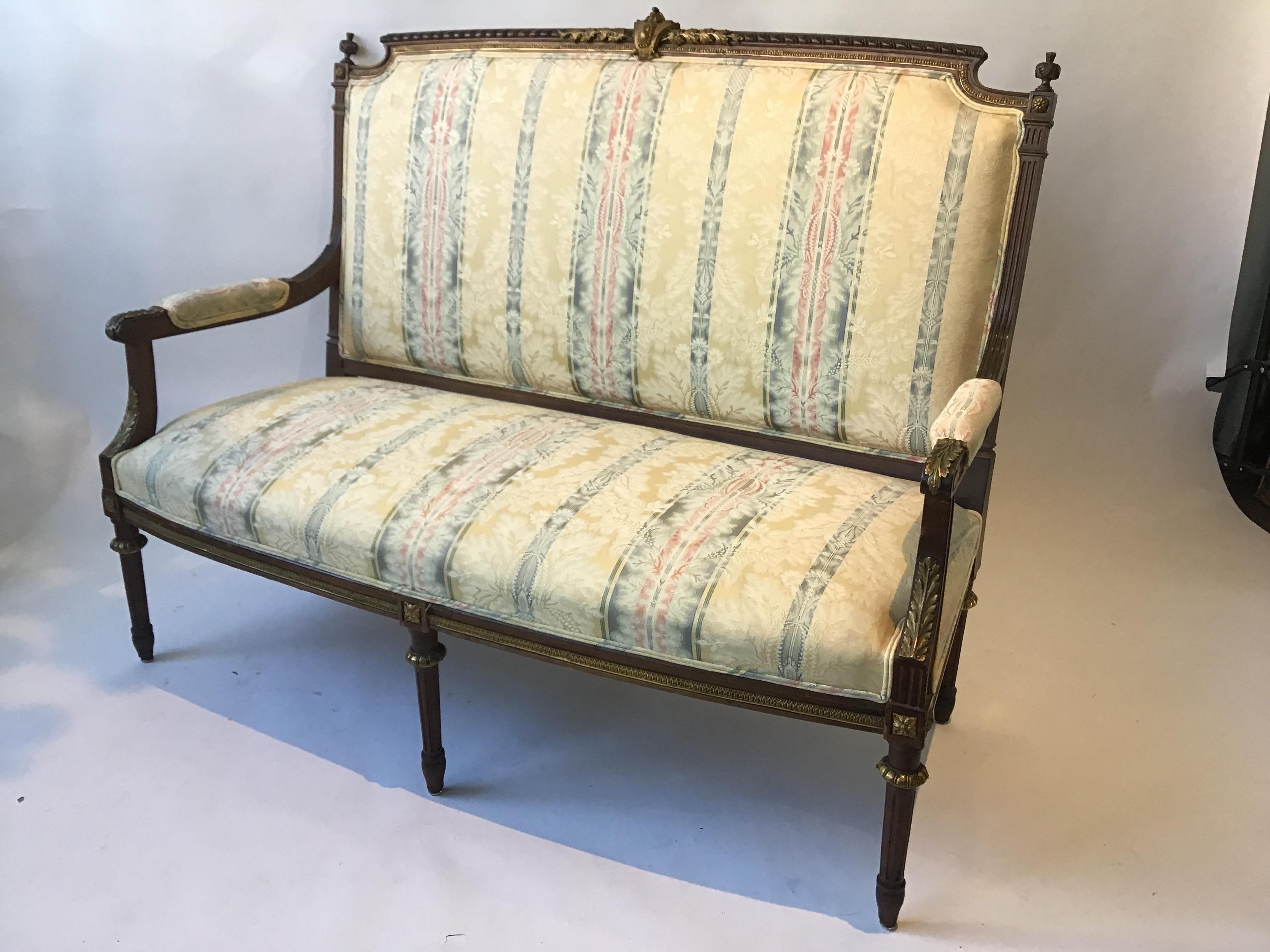 1920s French Louis XVI wood settee covered in bronze. All the gold accent pieces on the settee are bronze.