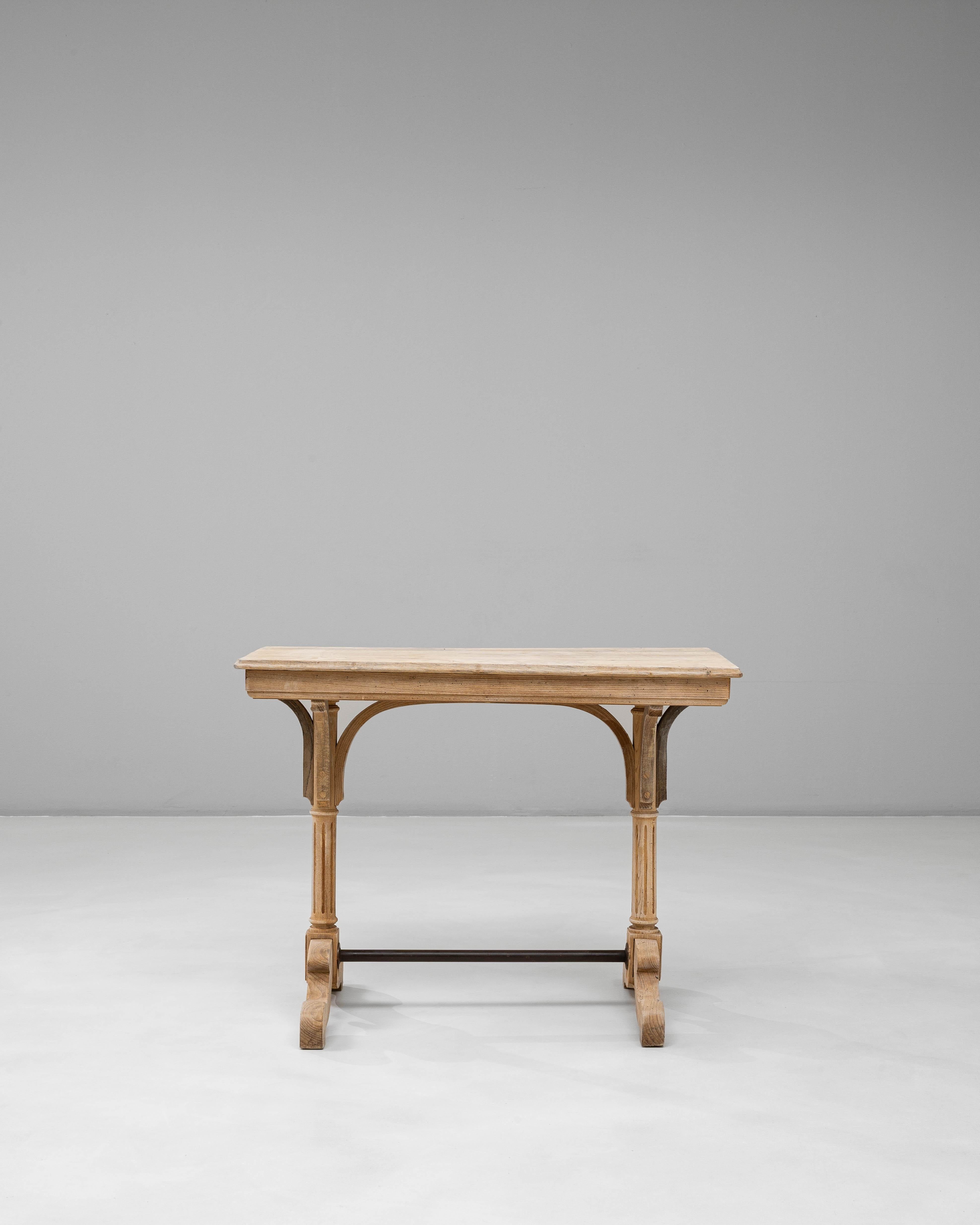 This 1920s French oak bistro table showcases the refined craftsmanship and understated charm characteristic of early 20th-century provincial design. The table features a rectangular top with softened edges and a beautifully worn surface that