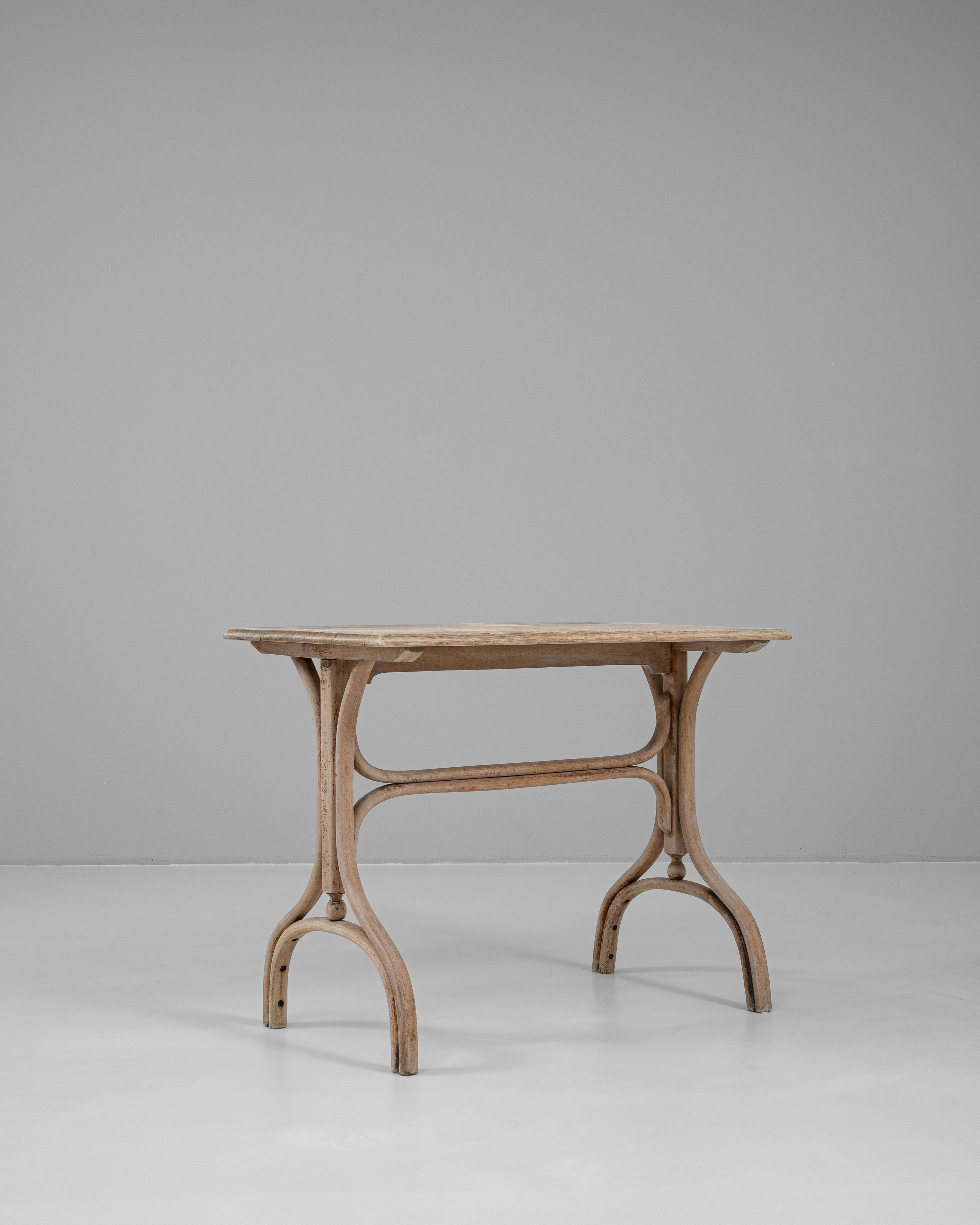 This 1920s French oak side table embodies graceful simplicity with its airy silhouette and finely crafted form. Made from solid oak, the table features a rectangular top with softly rounded edges and a beautifully worn finish that reveals the wood’s