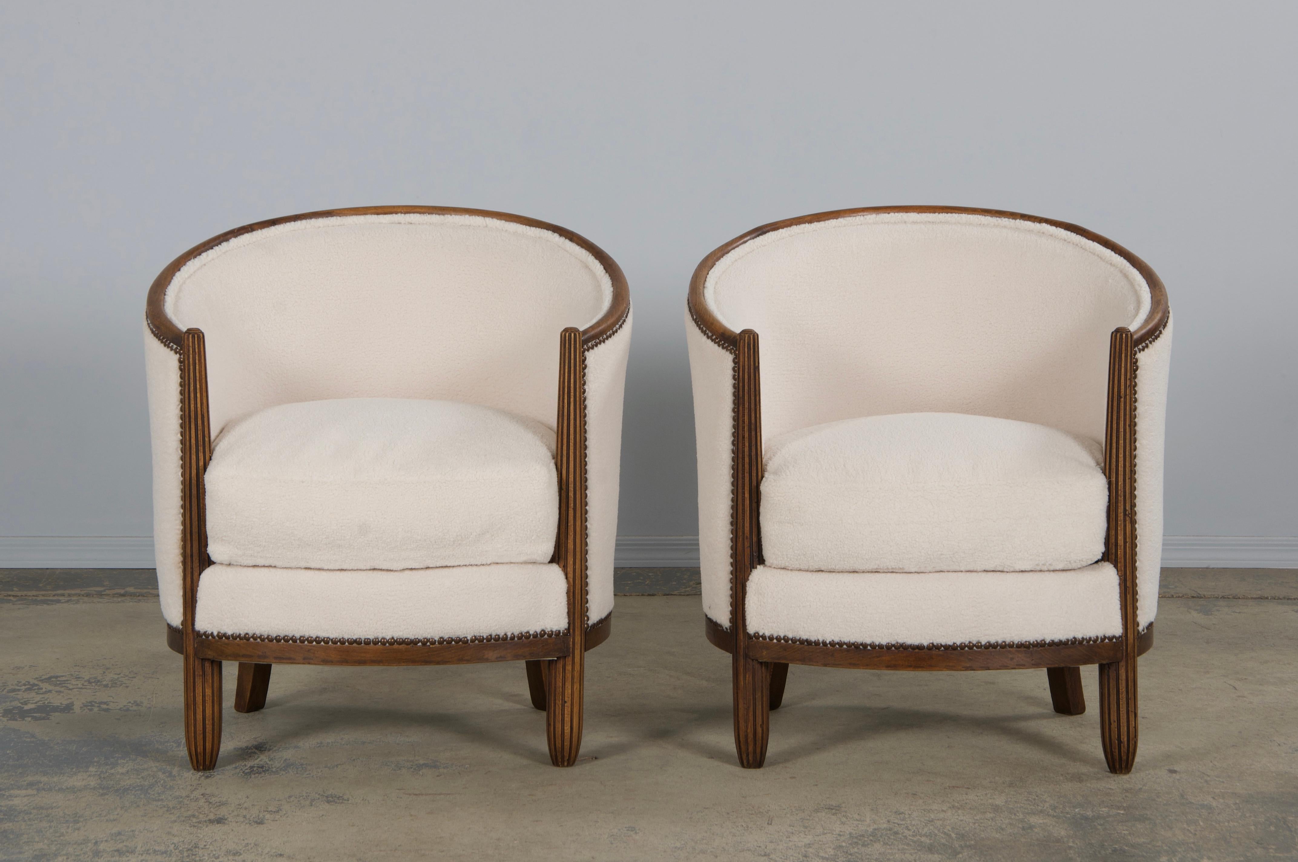 An exquisite pair of 1920s French Art Deco tub chairs, sourced in Paris as bare frames and fully transformed in our design studio. Each chair is hand-crafted from solid maple wood, featuring a classic tub silhouette with a carved oval back. They’ve