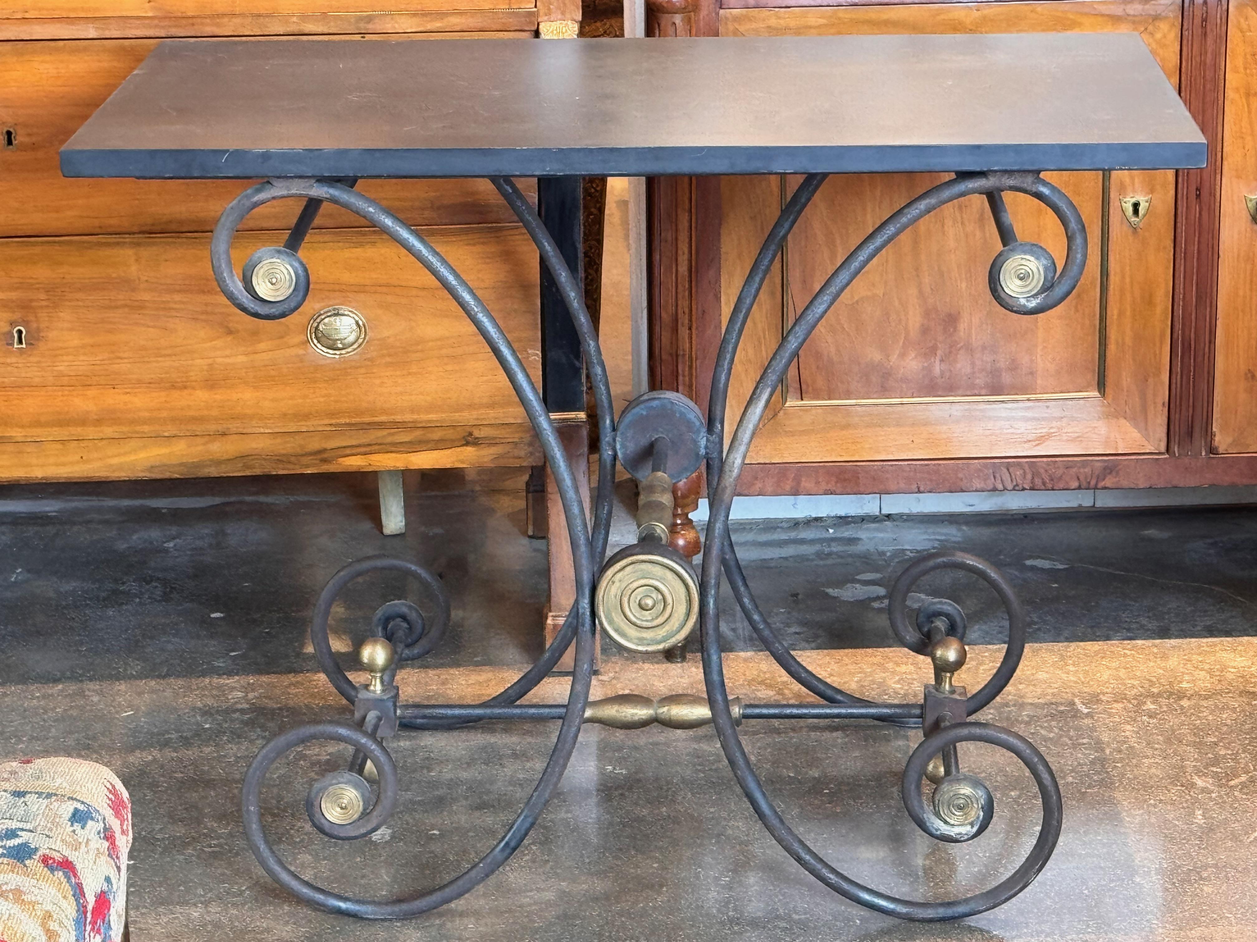 A handsome iron bakers table with a slate top. Perfect for in side or outside.
