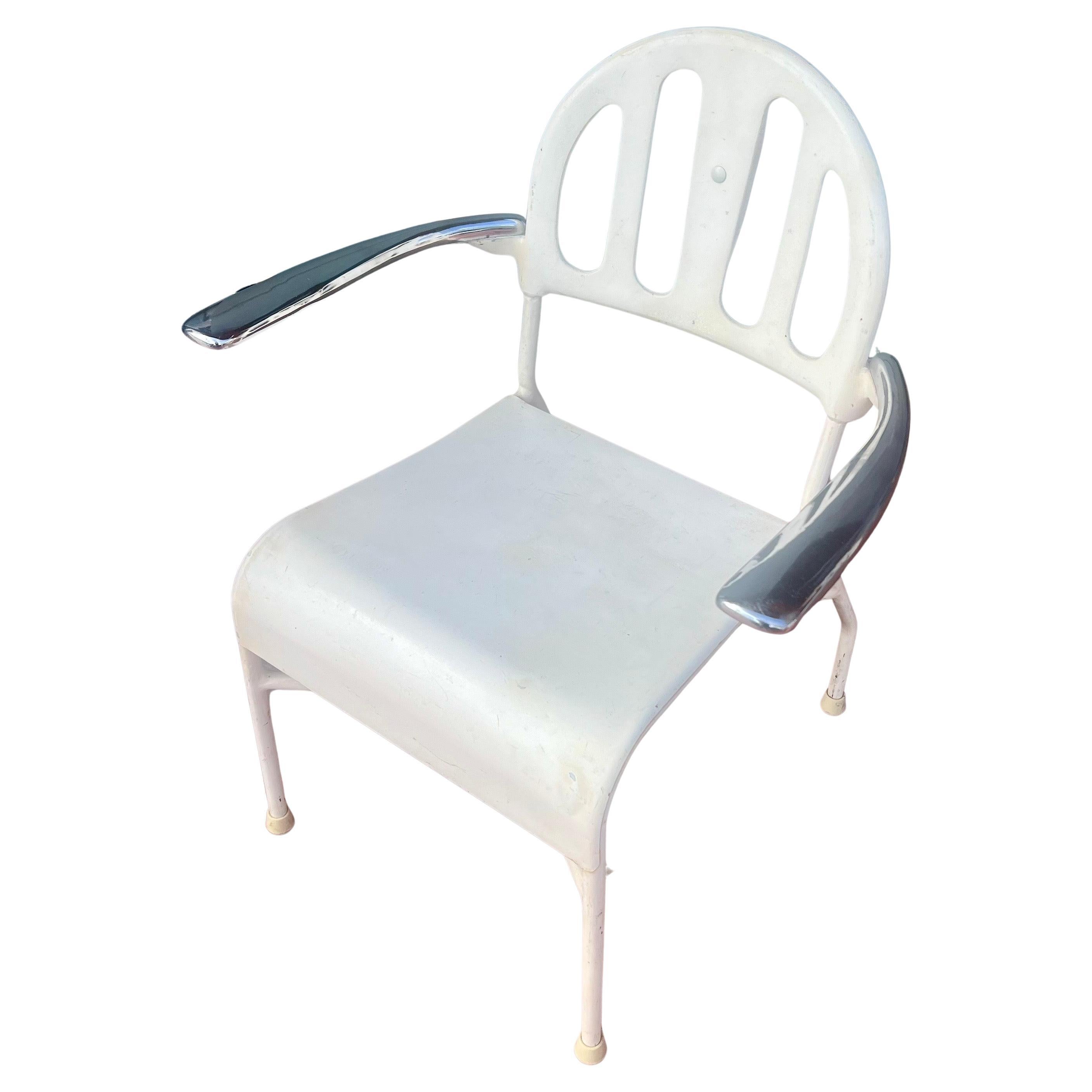 A very rare and unique armchair solid enameled steel with polished mirror shine arms , circa 1920's beauty parlor piece very nice and clean condition.