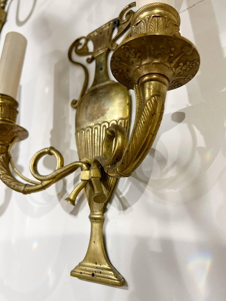 A circa 1920's French small gilt bronze urn shape sconces with twisted two arms