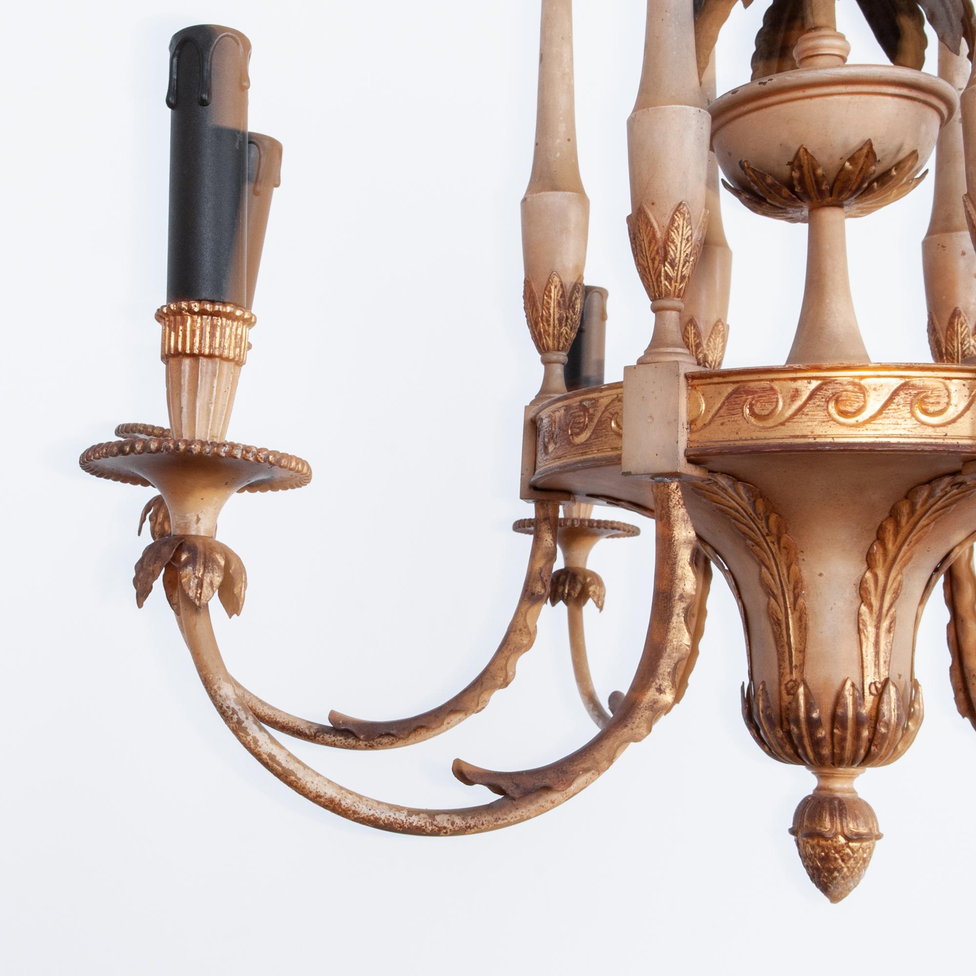 A refined and harmonious tole chandelier, decorative, but ordered. This 1920s decorative French chandelier has been electrified to modern standards, and fitted with E14 sockets. A typical period motif, these painted metal lamps were a created to