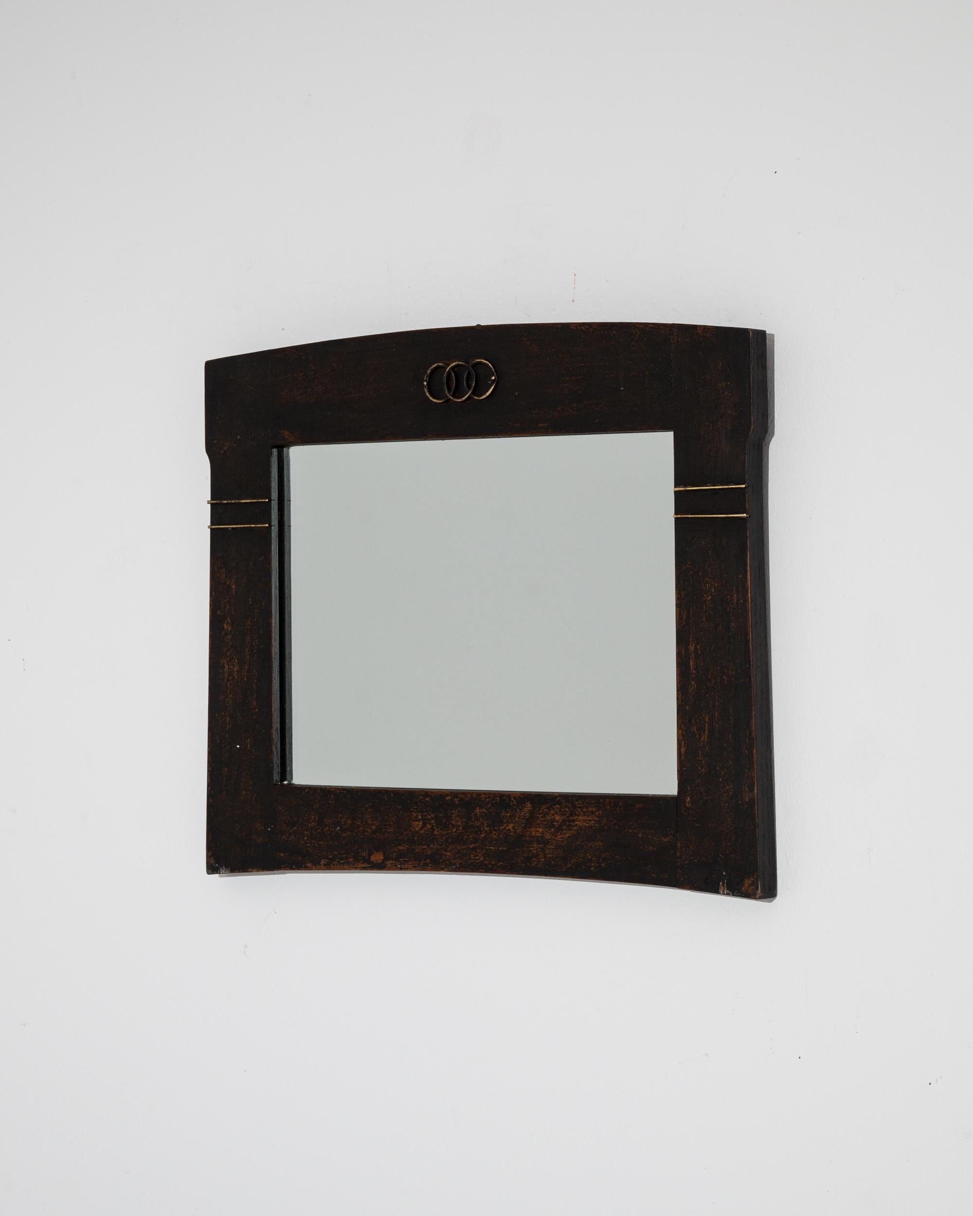 Elevate your space with the sophistication of this 1920s French Wood Black Patinated Mirror. The sleek black border is adorned with exquisite gold accent lines, adding a touch of opulence to its design. Two parallel gold lines on each side of the