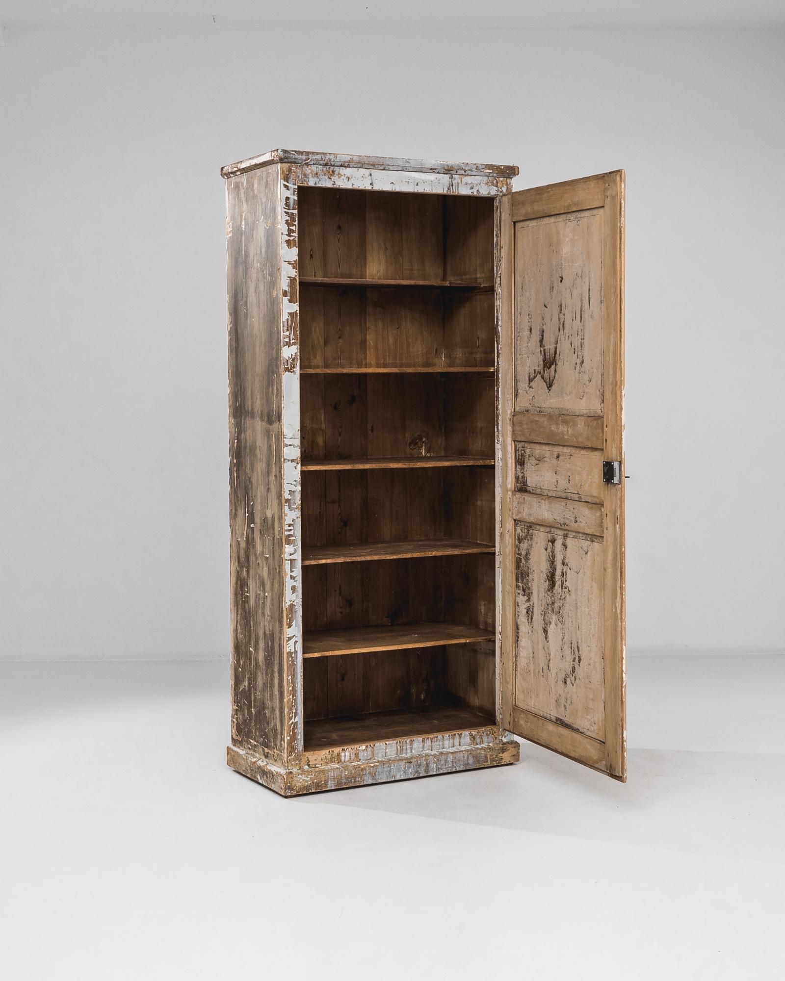 Step into the enchanting aura of the 1920s with this French Wood Patinated Cabinet, an exquisite blend of vintage charm and antique allure. The distressed patina adds character, reflecting the passage of time with a touch of nostalgia. Opening the