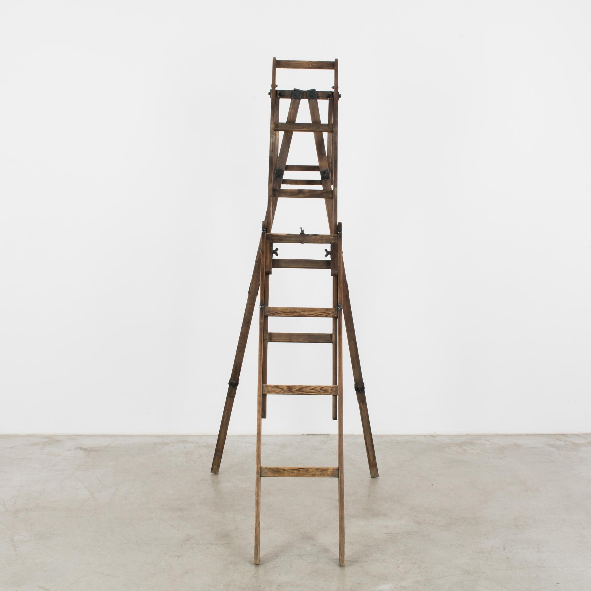 This wooden stepladder was made in France, circa 1920, and can be used in various ways, from displaying objects to sprucing up an interior space with a rustic accent piece. It is supported by two posts, which form a triangle on the opposite end. The