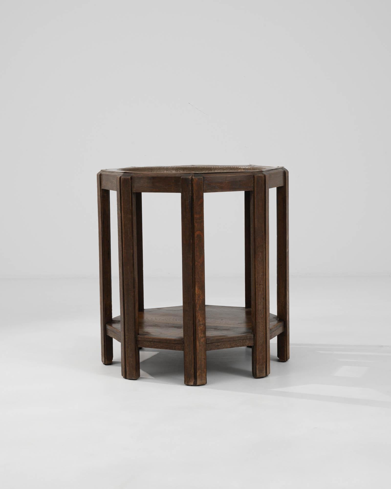 Discover the rustic charm and industrial flair of this 1920s French Wooden & Metal Side Table. A piece that truly encapsulates the fusion of form and function, this side table is a testament to the robust elegance of early 20th-century design.