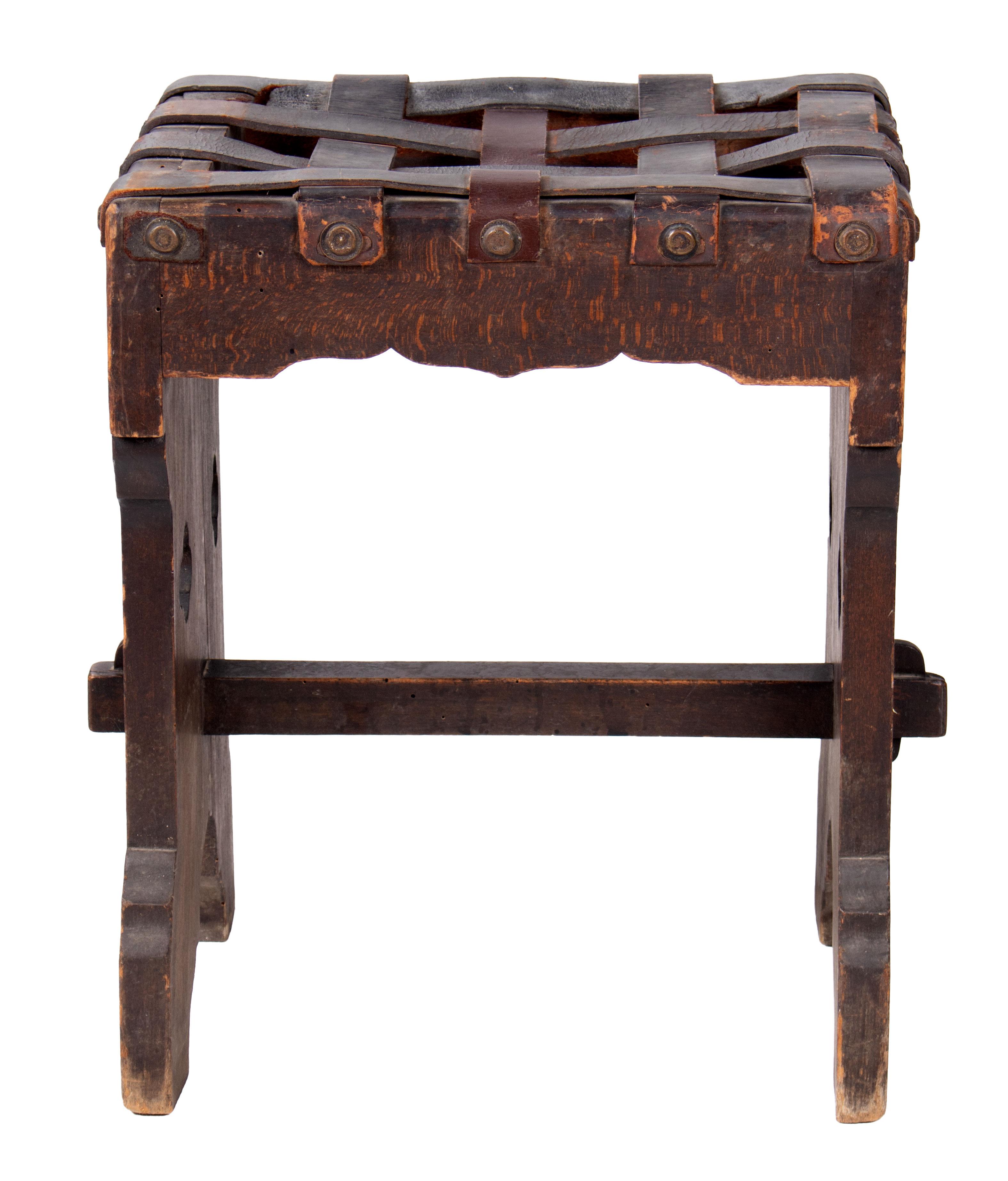 1920s French wooden stool with stringed leather seat.