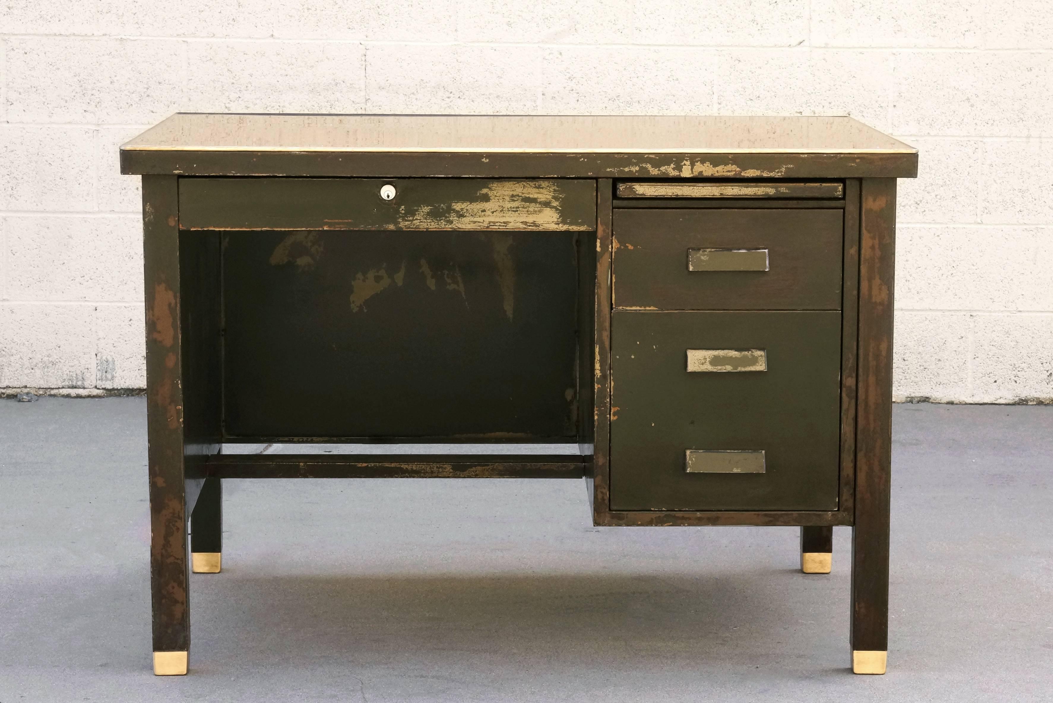 Very early model single pedestal tanker desk by General Fireproofing, circa 1920s. Its incredible patina is a combination of several layers of paint distressed over decades. Features refinished desktop with 1/8